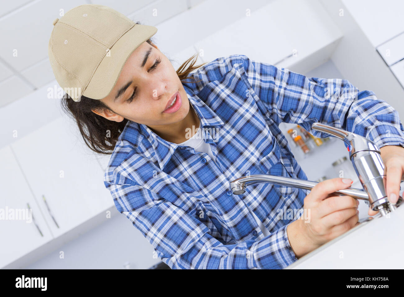 Female plumber fitting kitchen tap Stock Photo Alamy