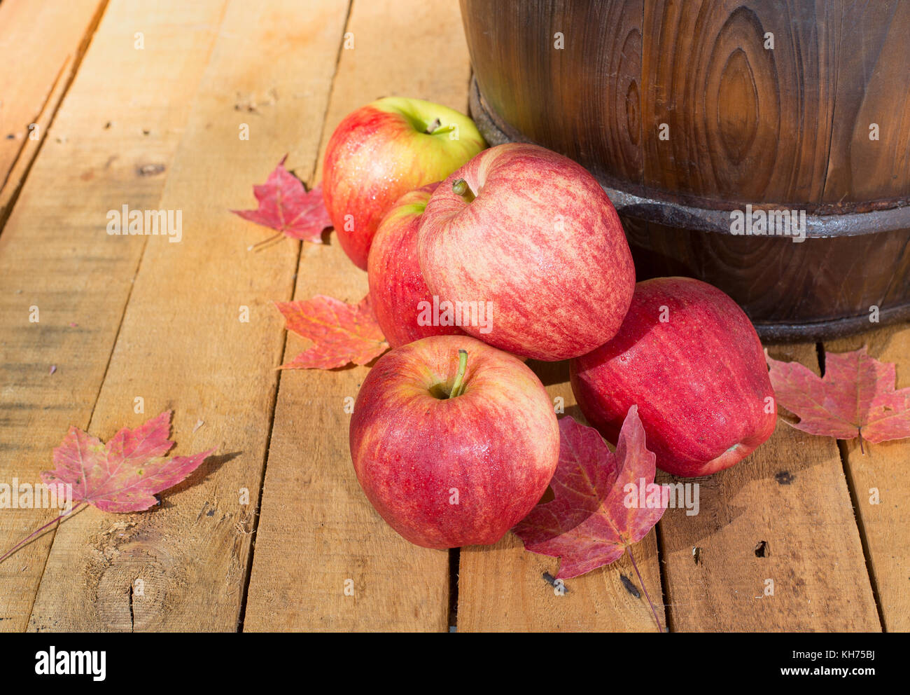 Red apples with autumn leaves on a wooden surface Stock Photo - Alamy