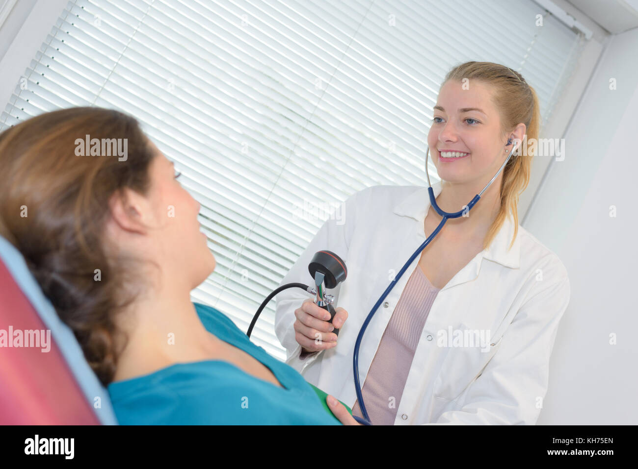 doctor auscultation using stethoscope auscultation women Stock Photo