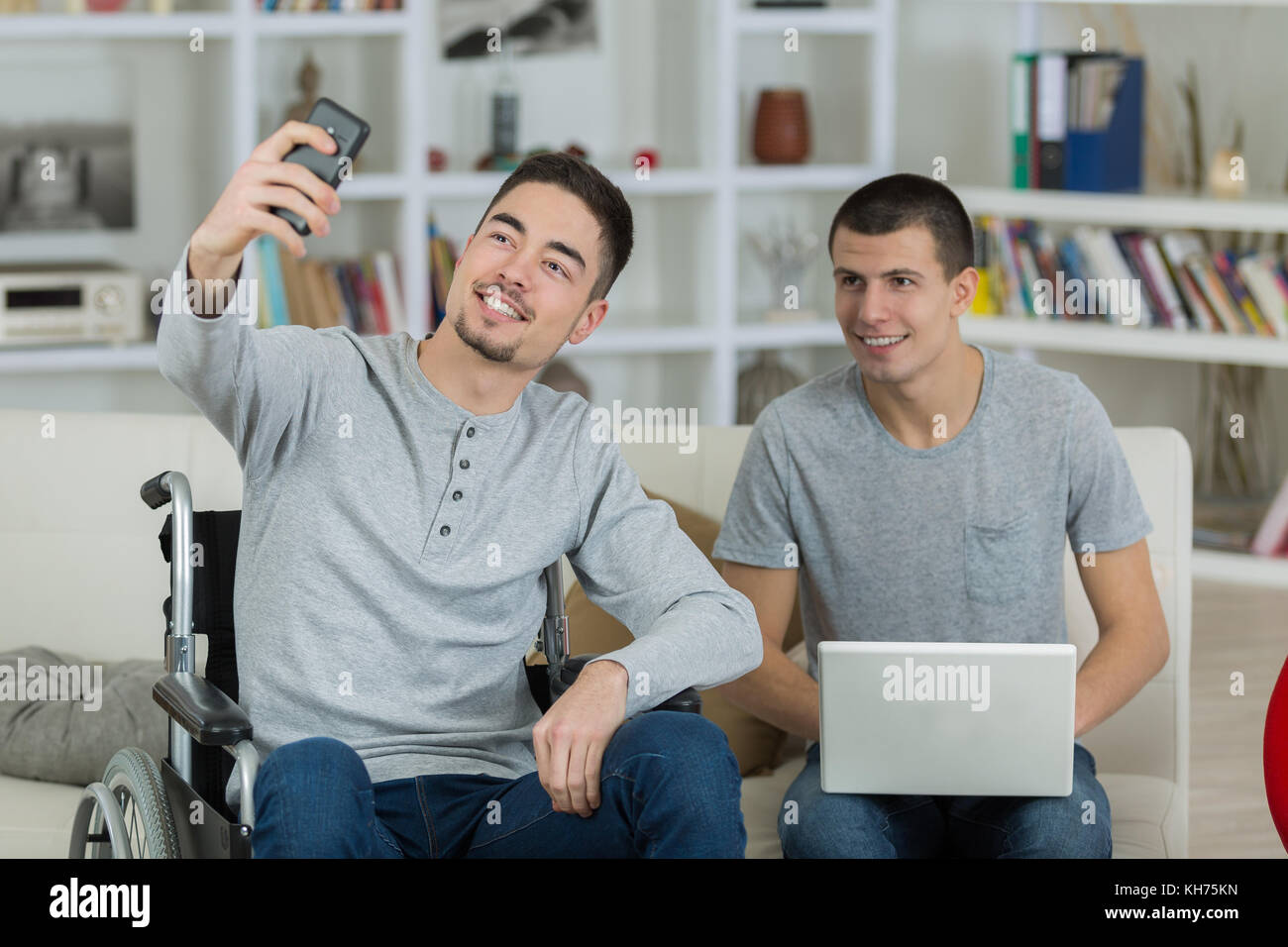 young man taking a selfie with his friend in wheelchair Stock Photo - Alamy