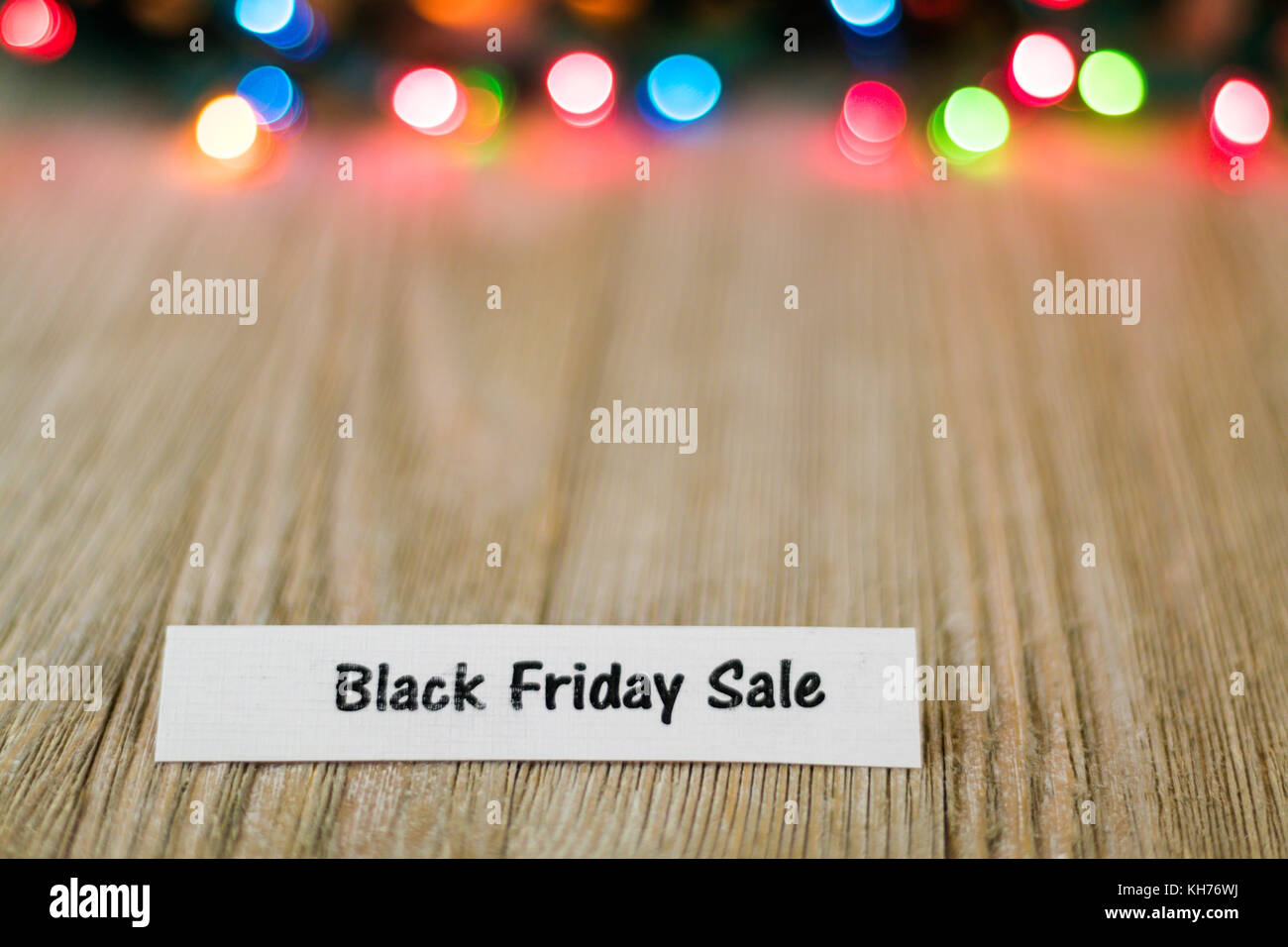 Sale Concept On Wooden Board And Colored Lights Selective