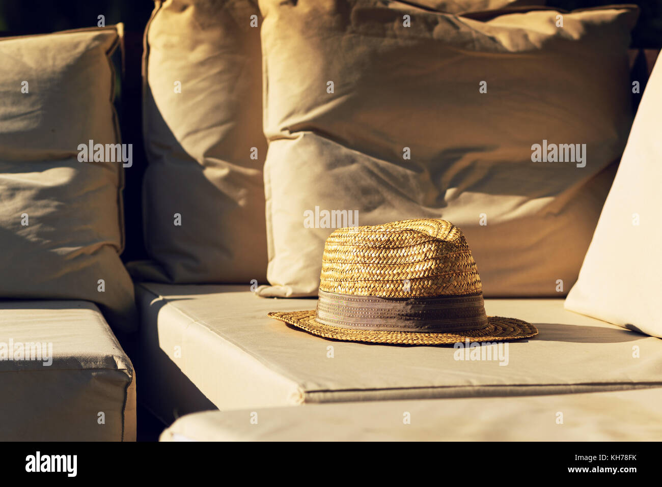 Straw Hat On Deck Chair By The Swimming Pool In Summer