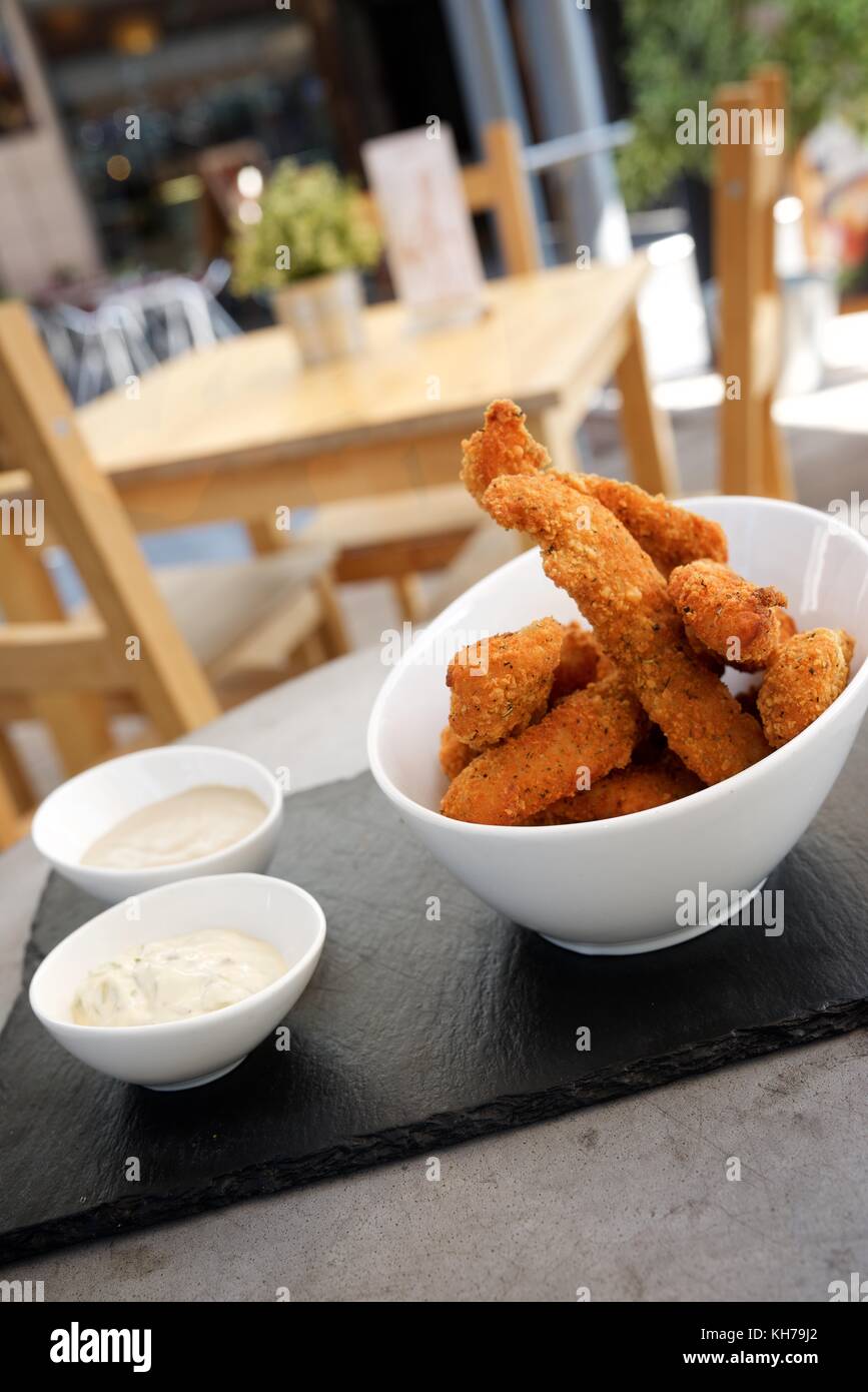 Chicken fingers on the terrace of a restaurant Stock Photo Alamy