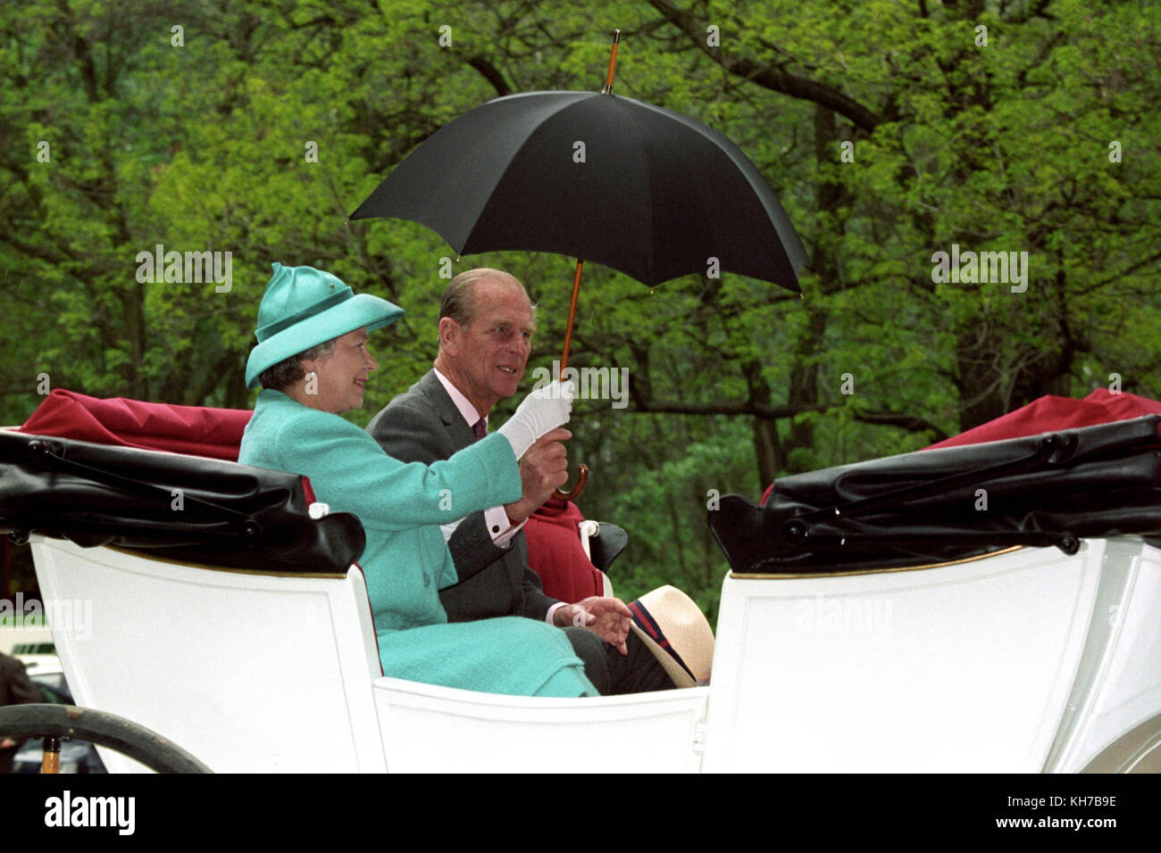 06/05/1993. Queen Elizabeth II and the Duke of Edinburgh share an umbrella whilst enjoying a horse-drawn carriage ride at Bugacs, on the Hungarian Plain during a State Visit to Hungary. The Royal couple will celebrate their platinum wedding anniversary on November 20. Stock Photo