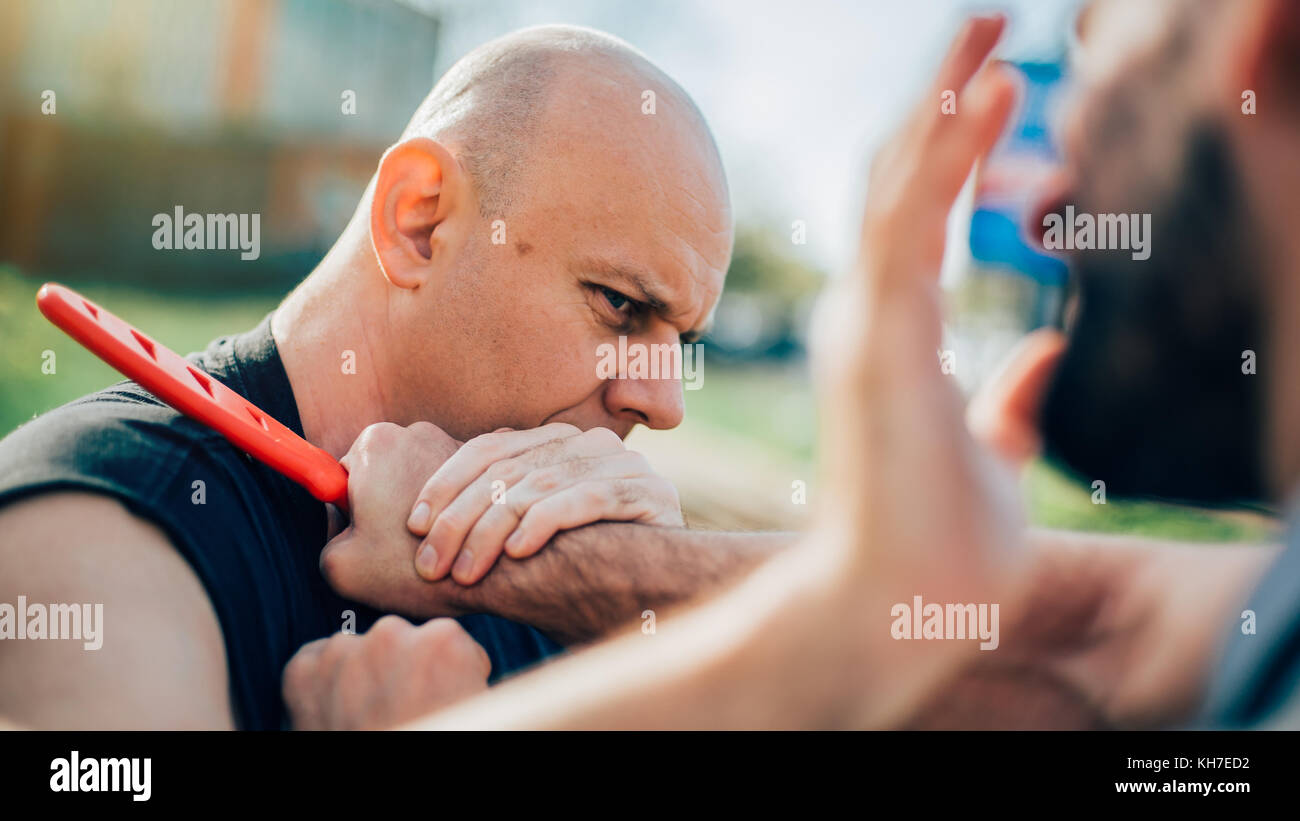 Kapap instructor demonstrates martial arts self defense disarming