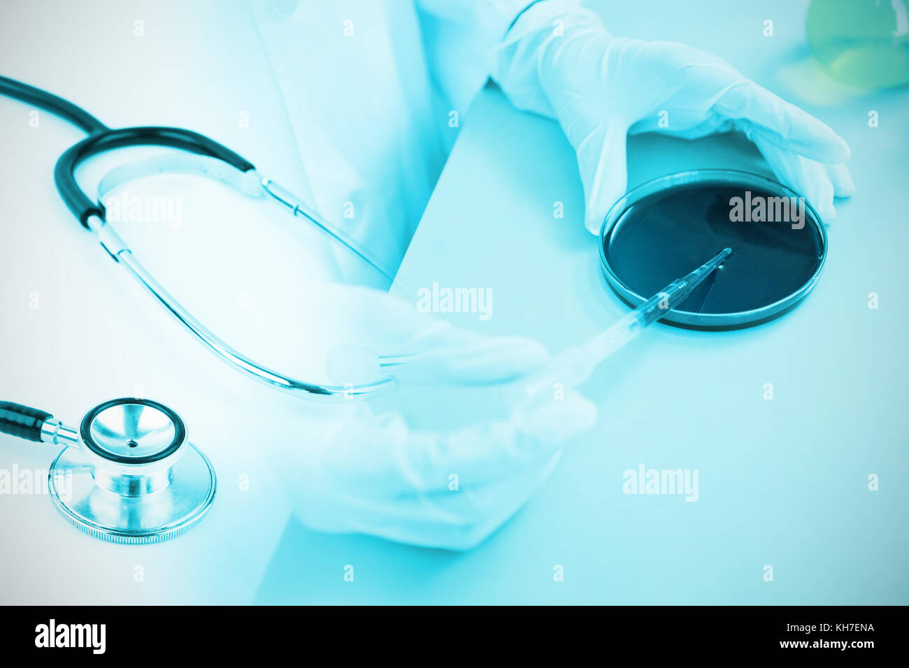 Metal black stethoscope against doctor holding microscope slide Stock Photo  - Alamy