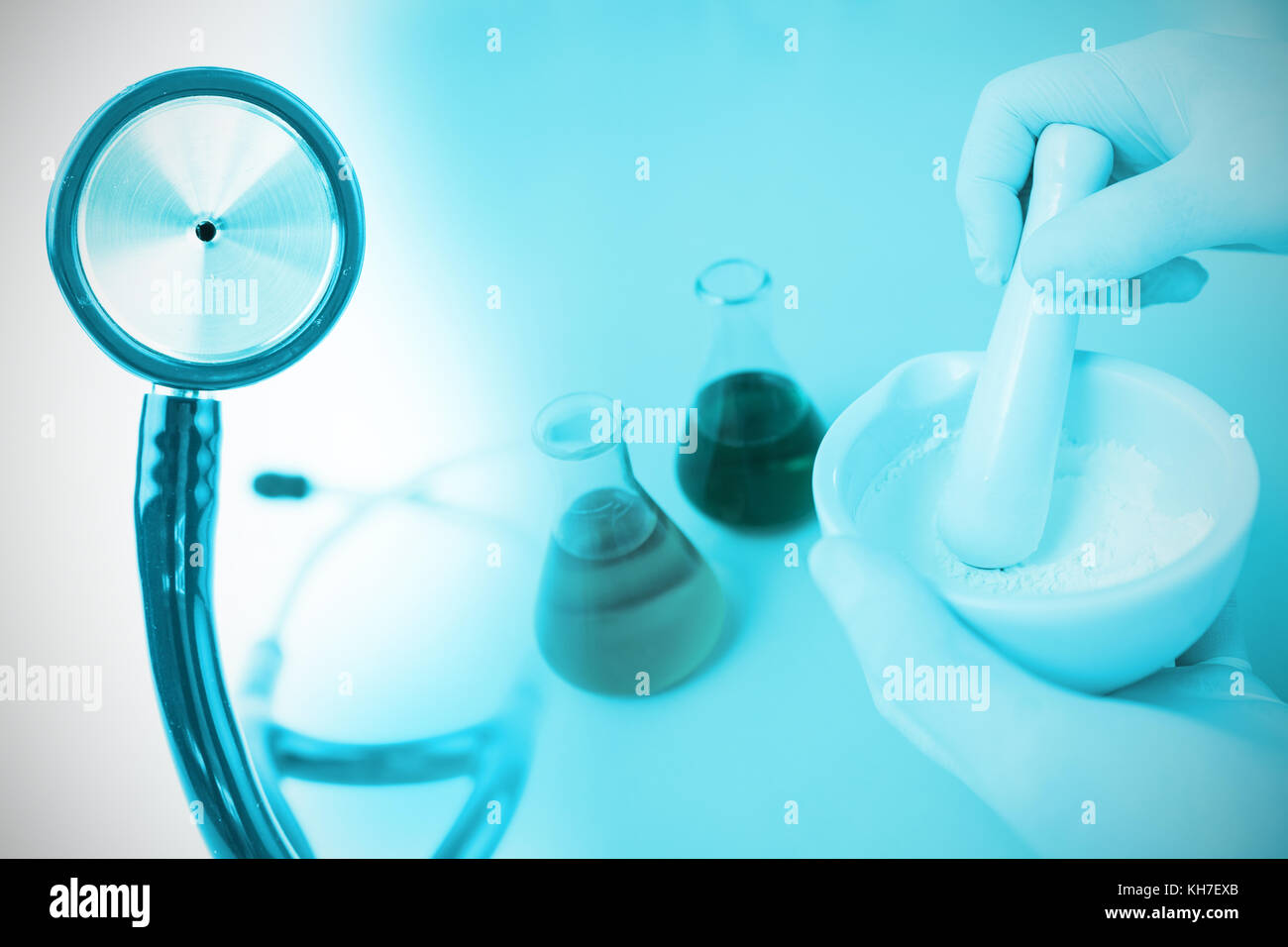 Part of the blue stethoscope against doctor preparing medicine in