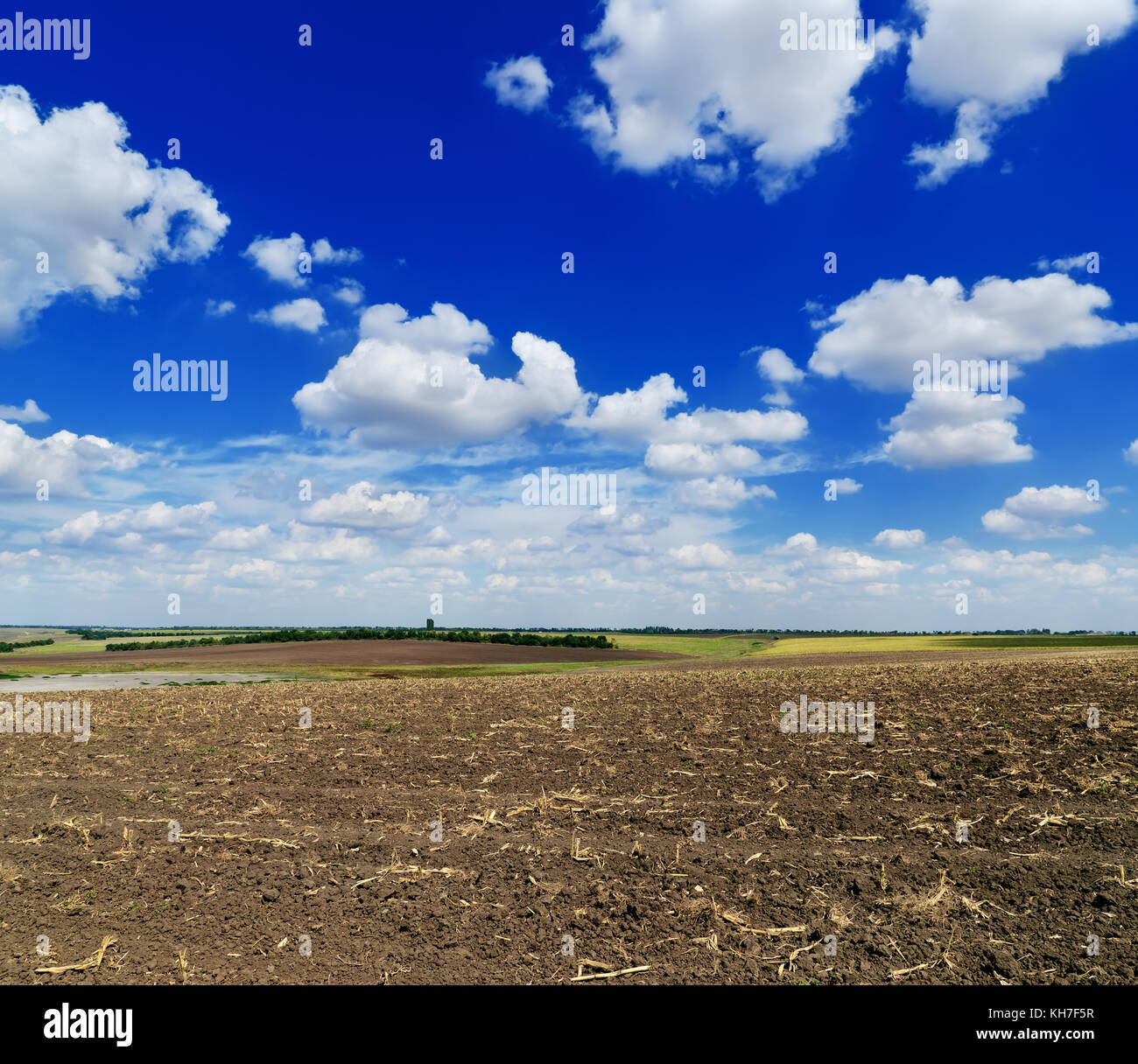 cloudy sky over black field after harvesting Stock Photo - Alamy