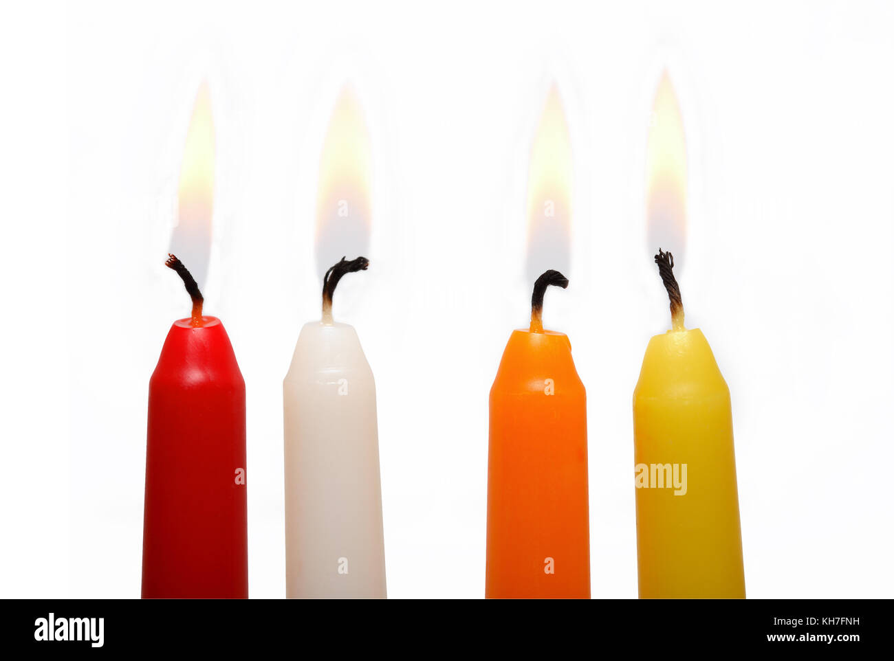 Set of four colored lighting candles on white background Stock Photo Alamy