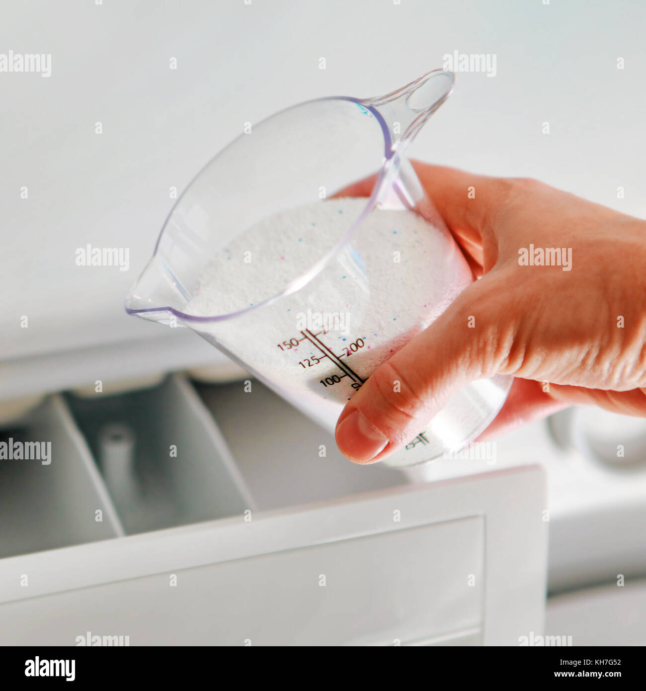 Washing Powder Detergent And Measuring Cup Pouring Into Machine. Household  Duties, Clothes Laundry Obejcts Concept. Stock Photo, Picture and Royalty  Free Image. Image 122874462.