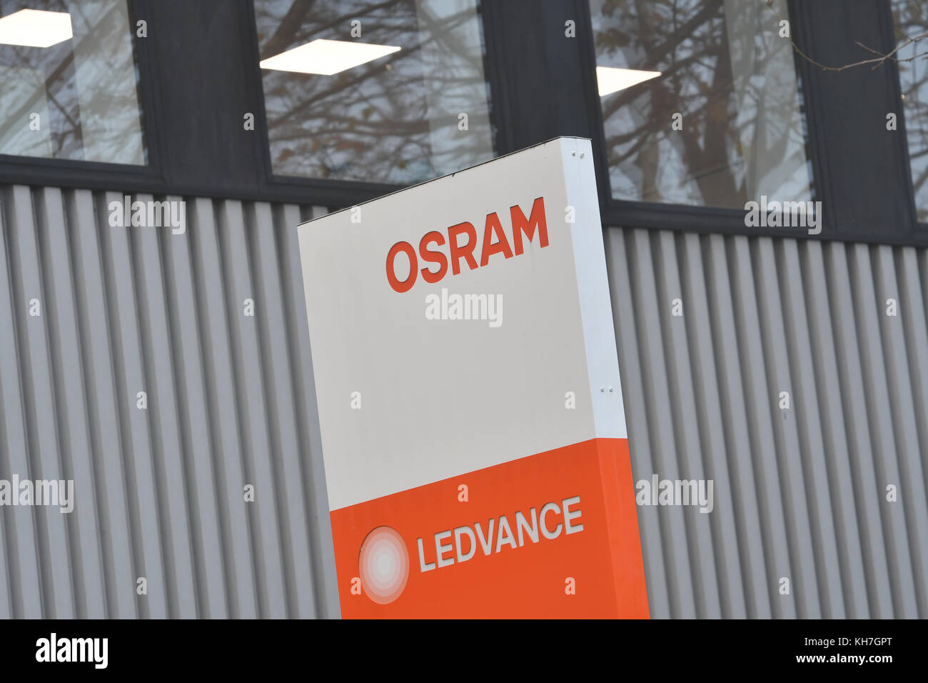 The logos 'Osram' and 'Ledvance' can be read on a board at the plant in Nonnendammallee, Berlin, Germany, 14 November 2017. The illuminant producer Ledvance is set to close down its plants in Berlin and Augsburg by the end of 2018. According to union information more than half of the workplaces in Germany are going to be cut. In march 2017 Osram sold its branch Ledvance, which was named in 2016, for more than 400 million euros to a consortium affiliated to the Chinese investor MLS. The company employs more than 9000 workers in 17 different locations around the globe. In Berlin 220 employees ar Stock Photo