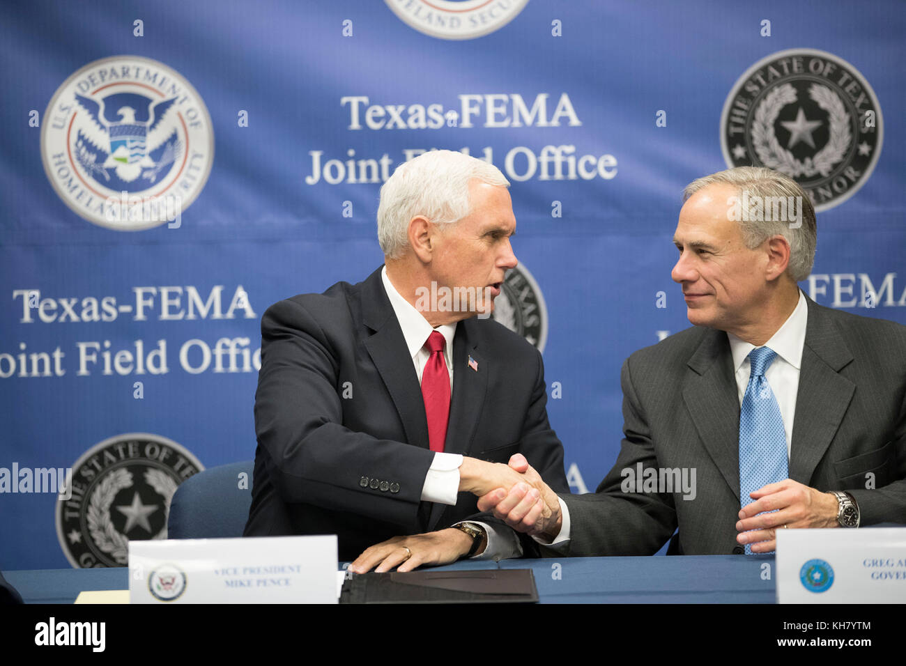 Austin, USA. 15th Nov, 2017. U.S. Vice President Mike Pence (left) greets Gov. Greg Abbott as he visits Federal Emergency Management Agency (FEMA) Texas regional office with Energy Secy. Rick Perry for a Hurricane Harvey recovery update from Texas Gov. Greg Abbott. Credit: Bob Daemmrich/Alamy Live News Stock Photo