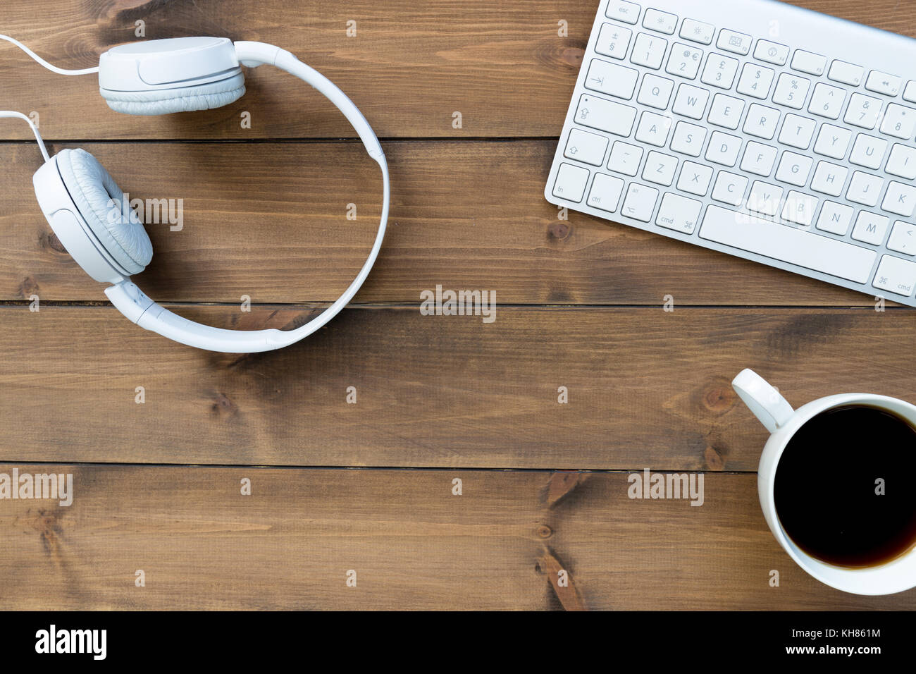 Computer Keyboard Music Headphones And Coffee On Wood Desk Stock