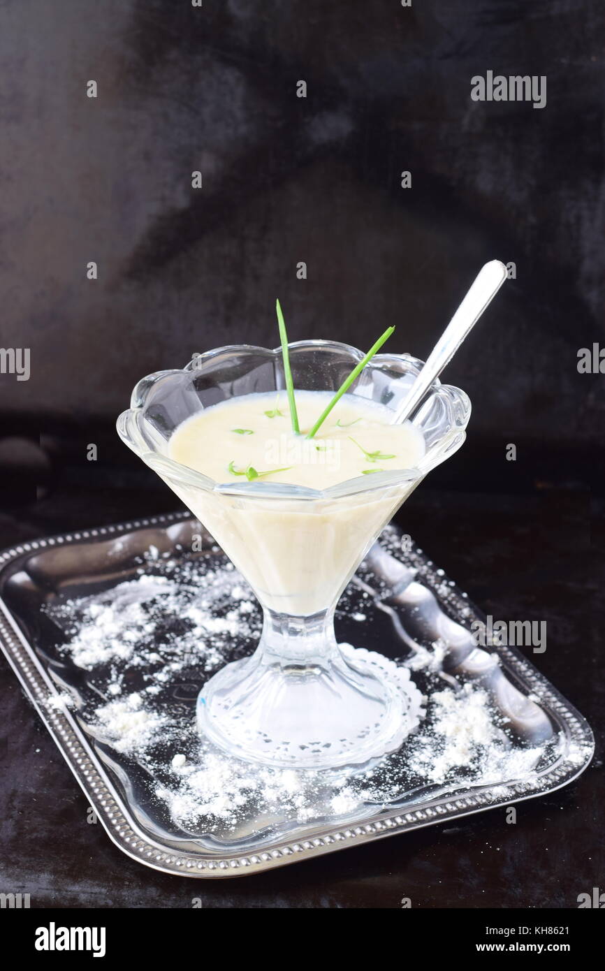 Simple easy to cook milk based gravy in a glass on a metal tray. Healthy food concept Stock Photo