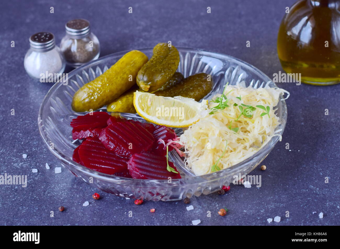 Healthy lunch or dinner with smoked mackerel, pickled cucumbers, beetroot, sauerkraut, french fries on a grey abstract background. Healthy food. Food  Stock Photo