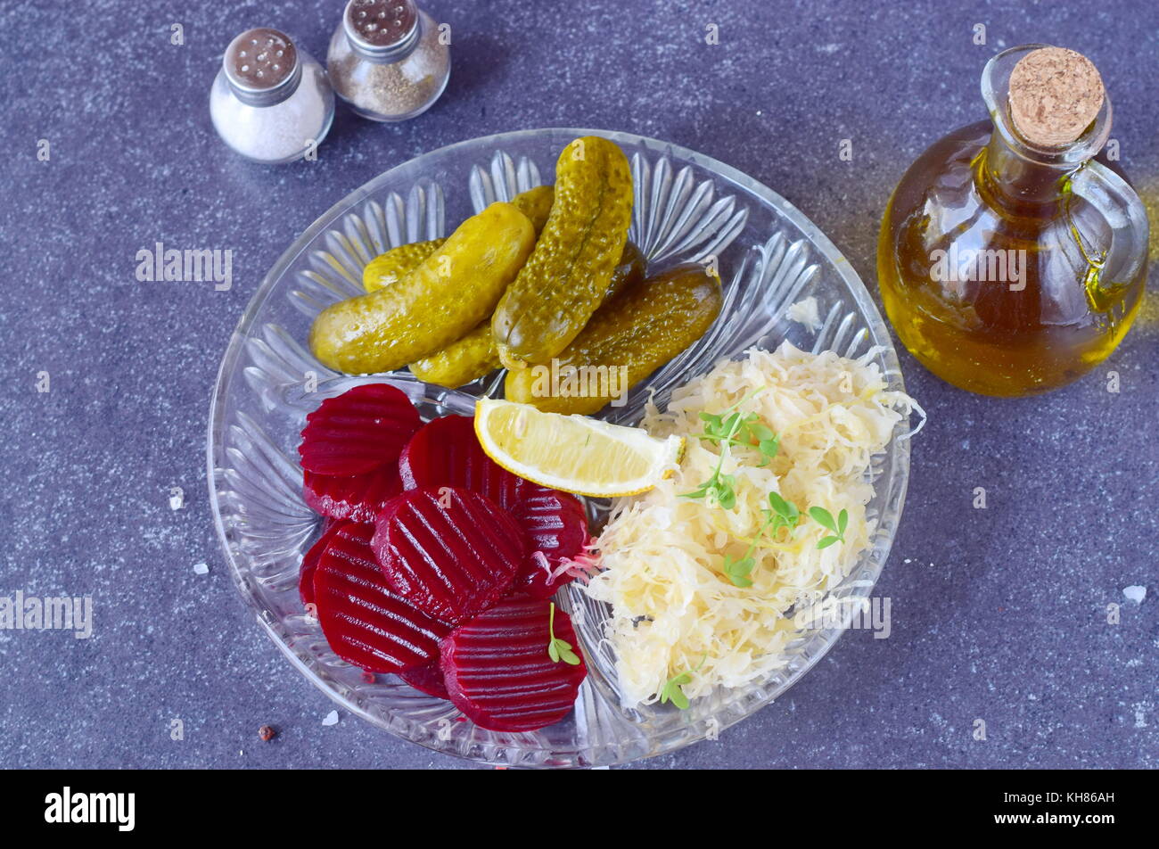 Healthy lunch or dinner with smoked mackerel, pickled cucumbers, beetroot, sauerkraut, french fries on a grey abstract background. Healthy food. Food  Stock Photo