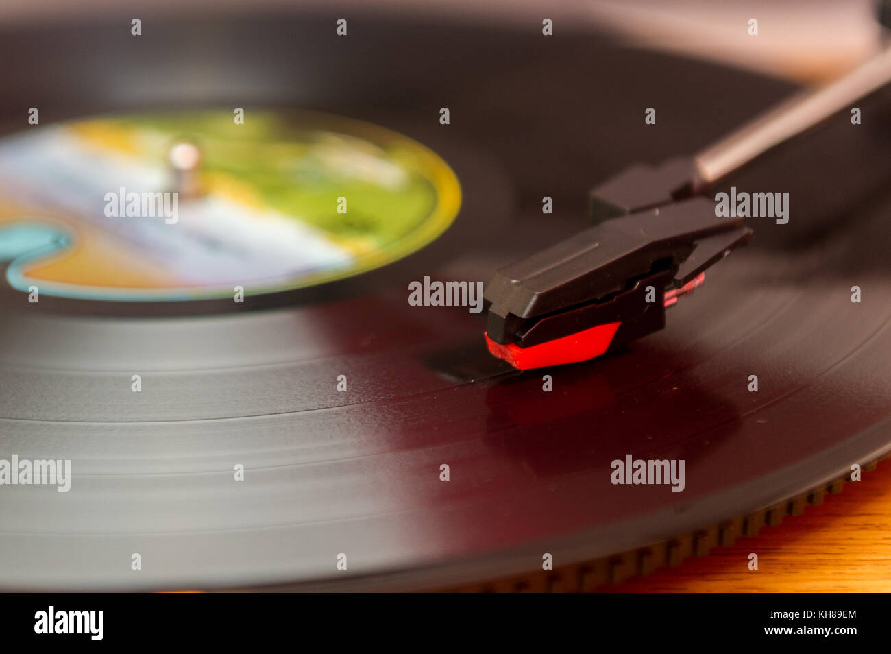Vinyl record album playing on a record player, turntable. Stock Photo