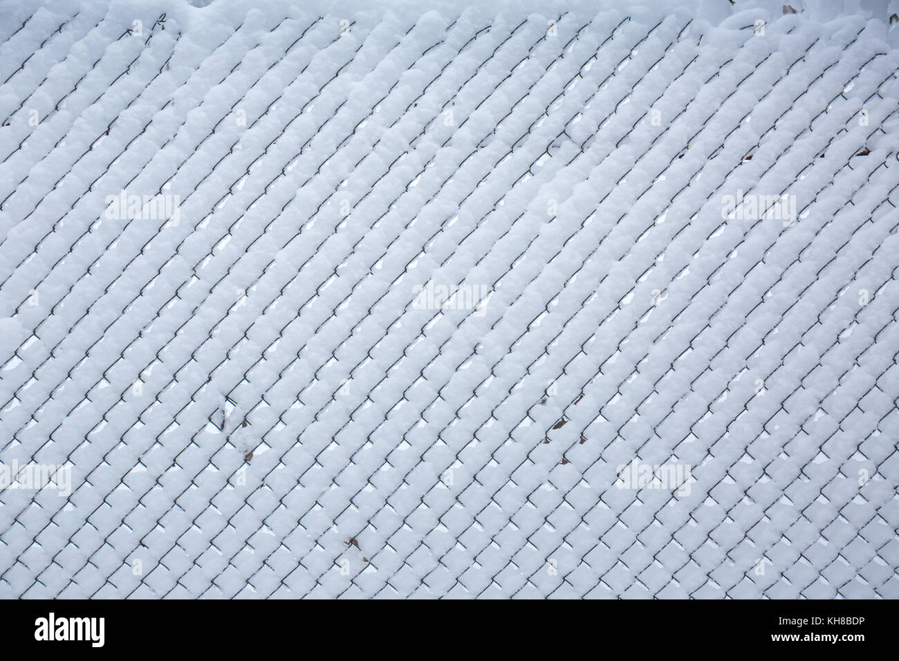 Snow covered fence from the grid. winter background Stock Photo - Alamy
