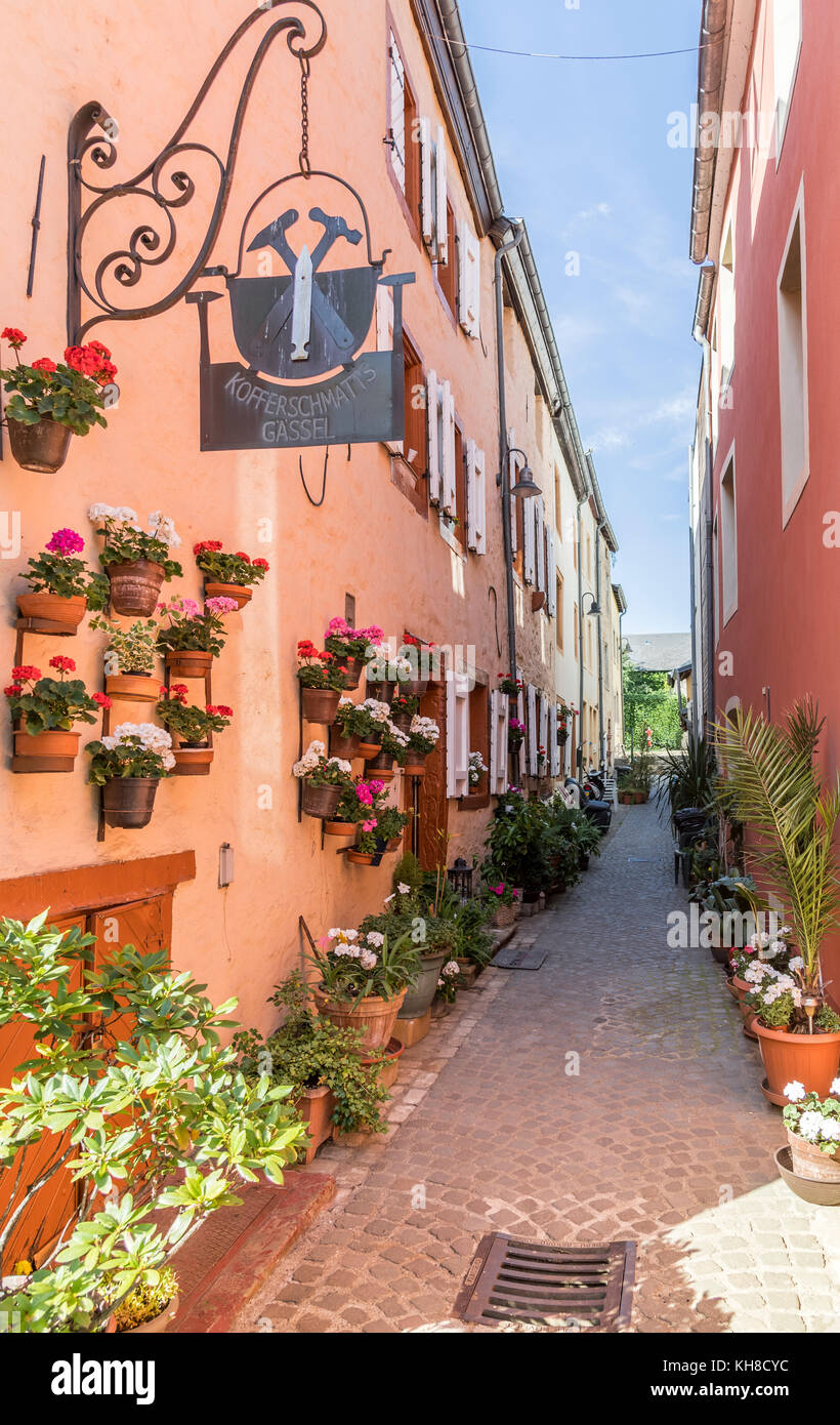 Narrow alleyway through houses decorated with flowers, Grevenmacher, Luxembourg Stock Photo