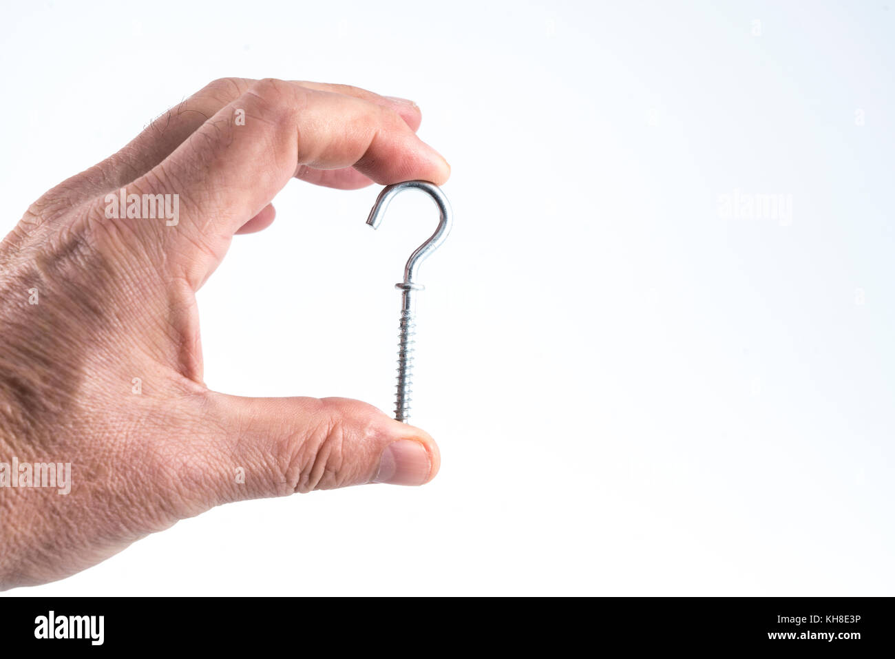 a small metal clip between the fingers Stock Photo