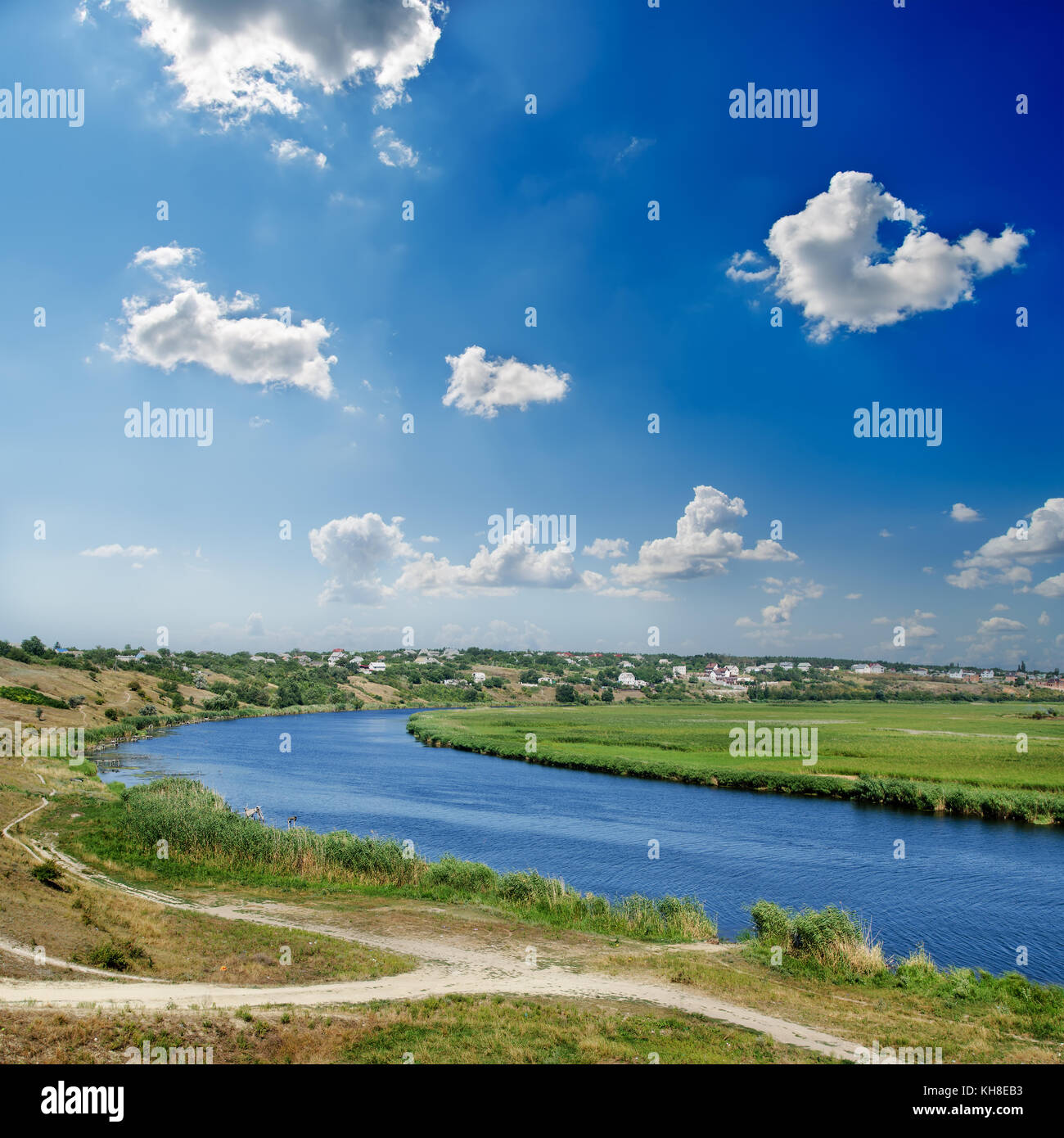 river and deep blue sky with clouds Stock Photo - Alamy