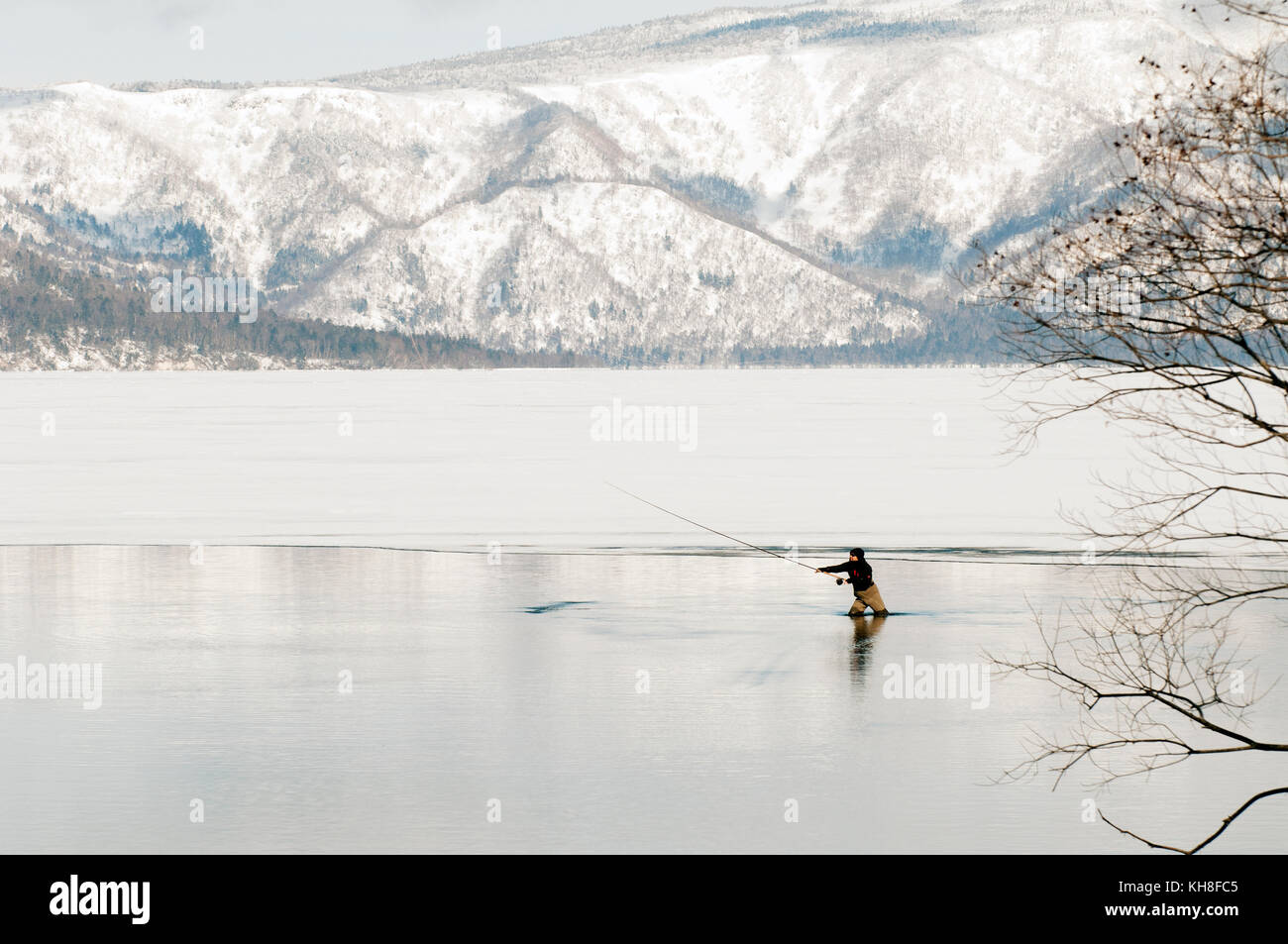 Japan, Hokkaido, Fisherman in winter *** Local Caption ***  landscape,winter,snow,cold,fishing,frozen lake Stock Photo