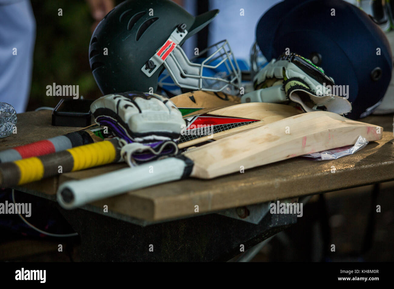 Cricket accessories with helmets and bats Stock Photo Alamy