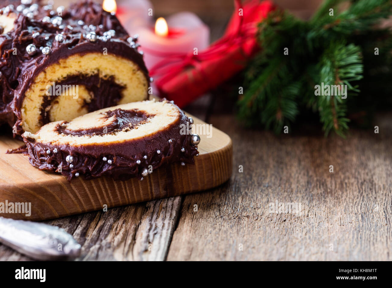 Christmas chocolate log, Buche de Noel, festive holiday cake on rustic table background Stock Photo