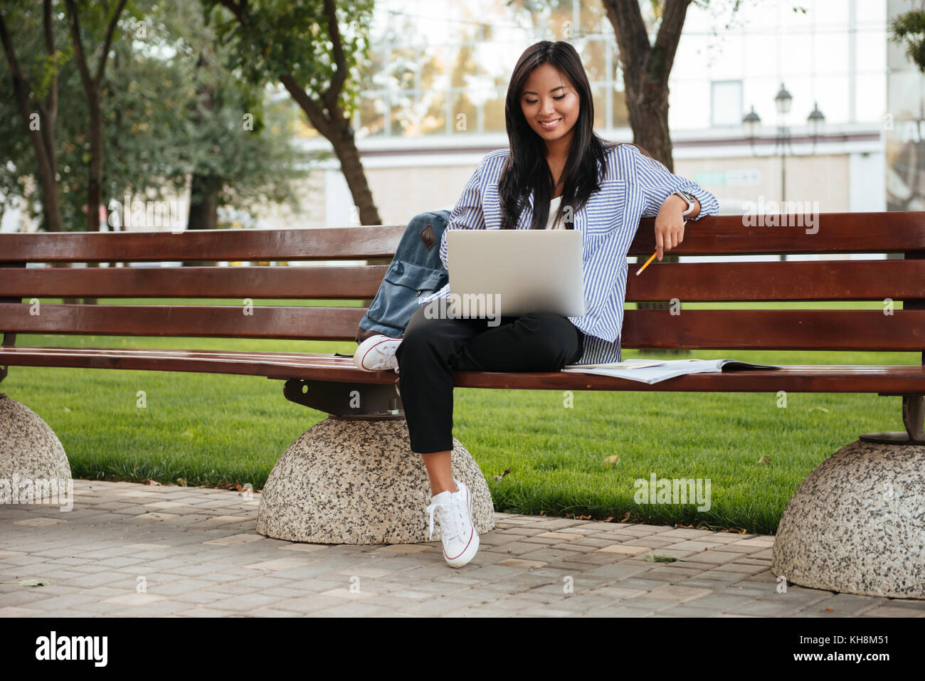 Photo of young happy asian female student relaxing with laptop, sitting ...