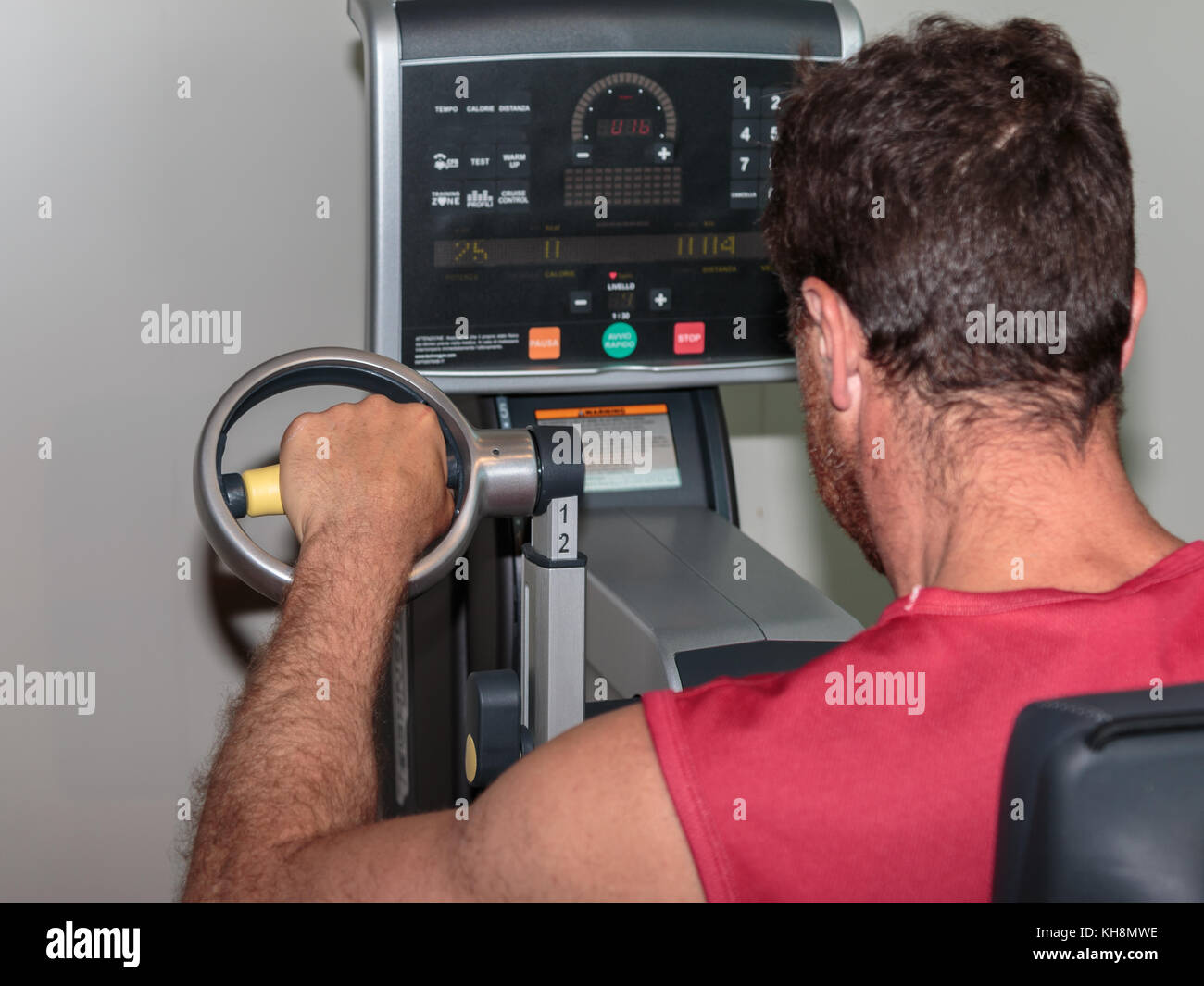 Man at Gym Cardiovascular Exercise at Gym with Upper Arm Bike Stock