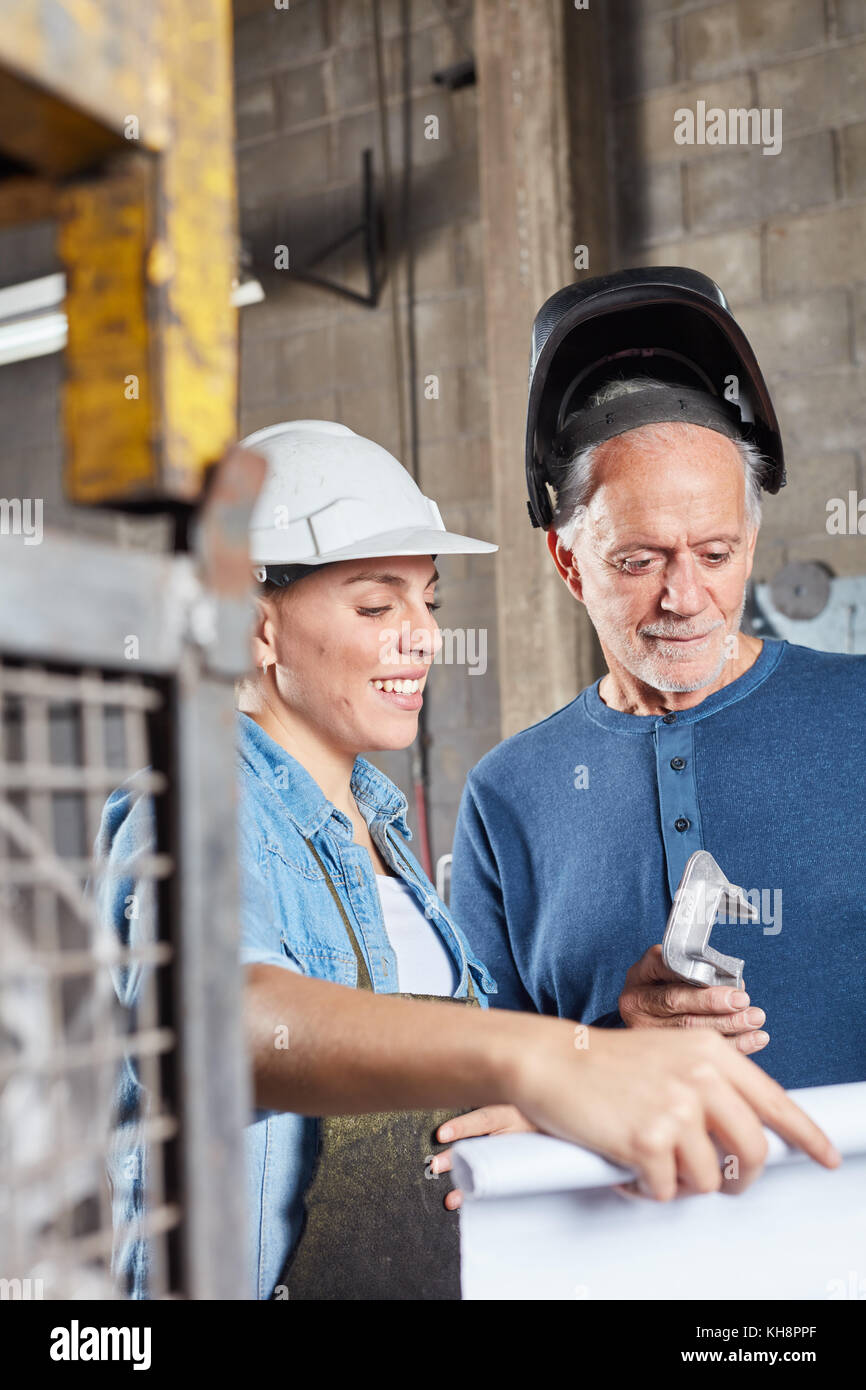 Teamwork Metal Worker and team working on metal construction in teamwork Stock Photo ...