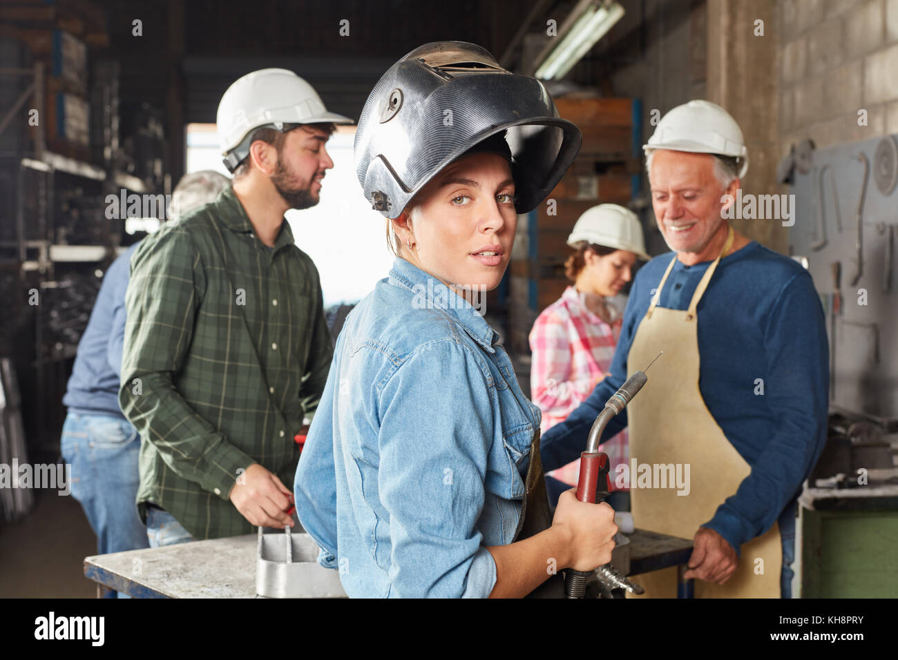 Young woman in apprenticeship lesson as blue collar worker Stock Photo