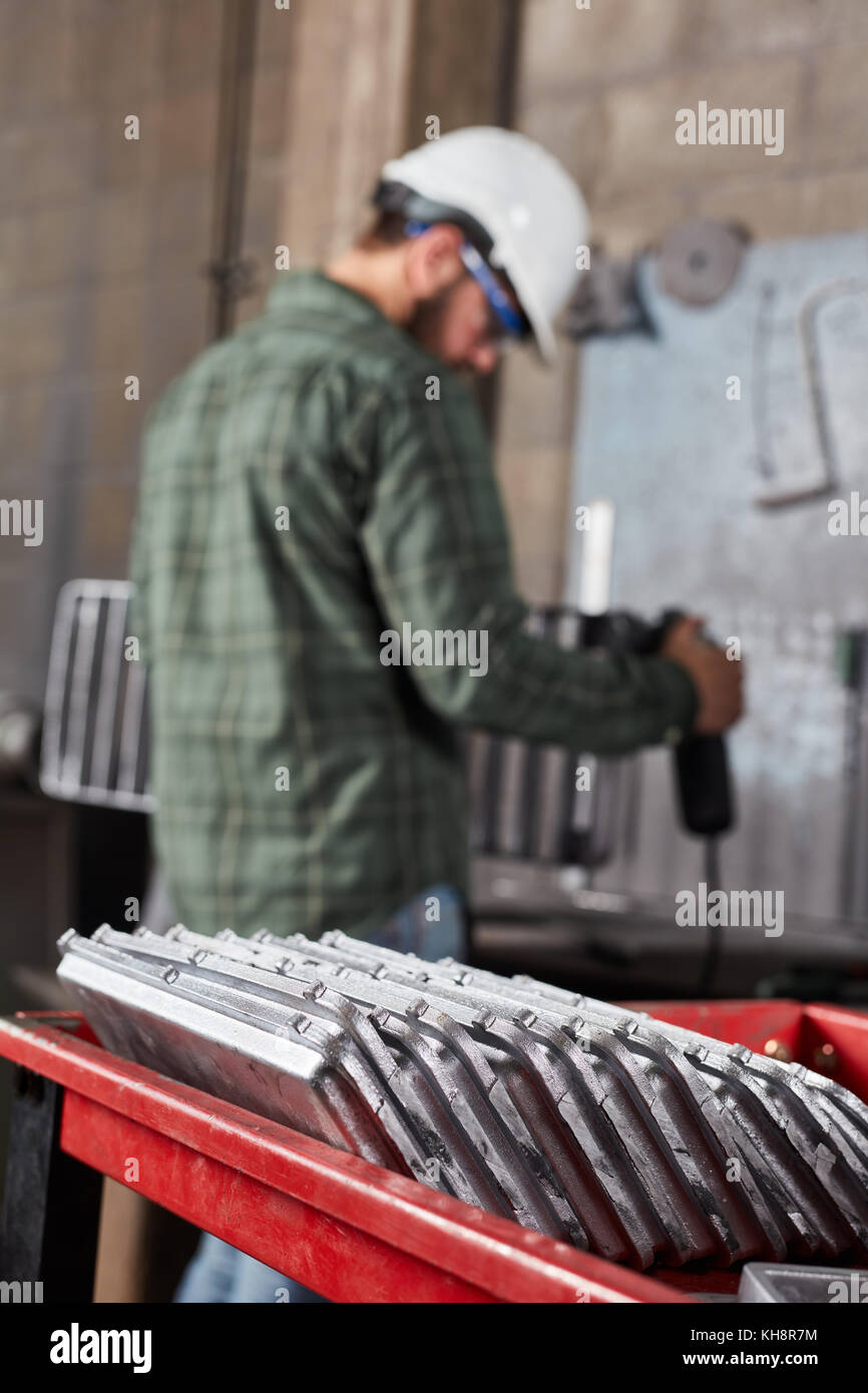 Metal factory with metalworker during metallurgy production Stock Photo