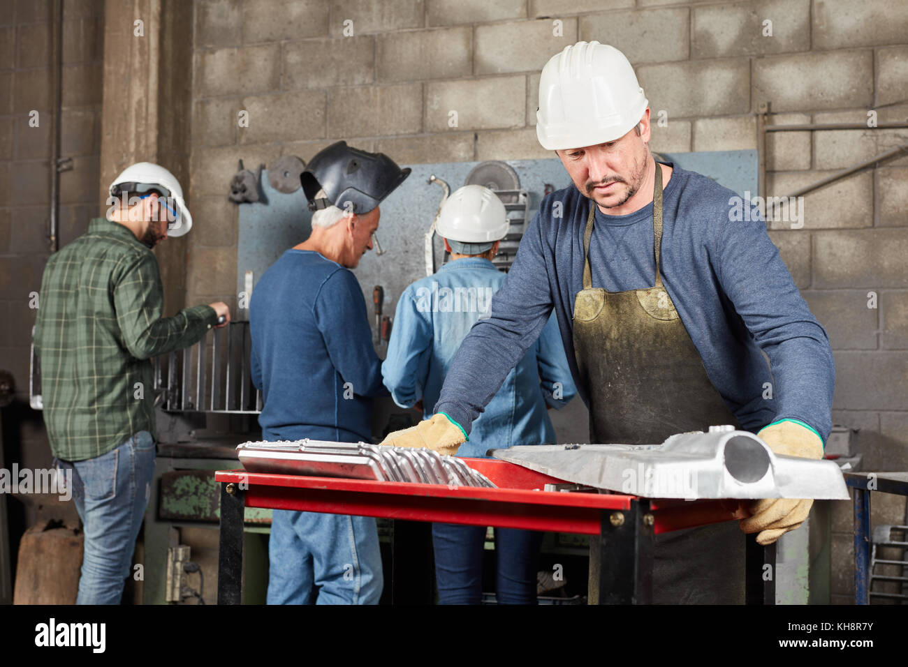 Blue collar worker controls metal construction and production Stock Photo