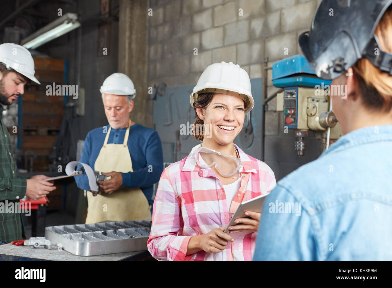 Young woman as trainee or apprentice in metal construction Stock Photo