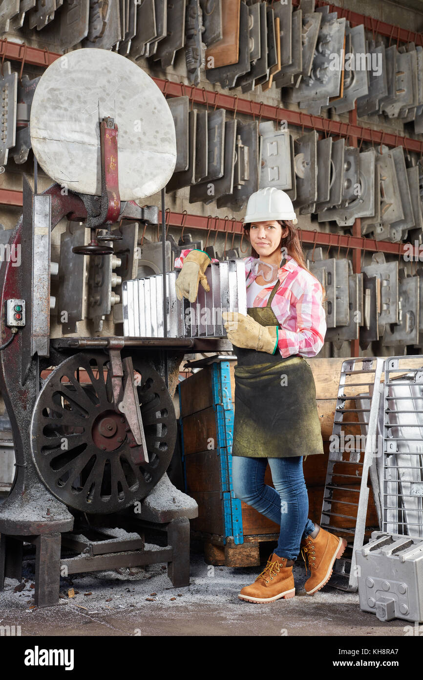 Young woman in metal construction factory with cast iron Stock Photo ...