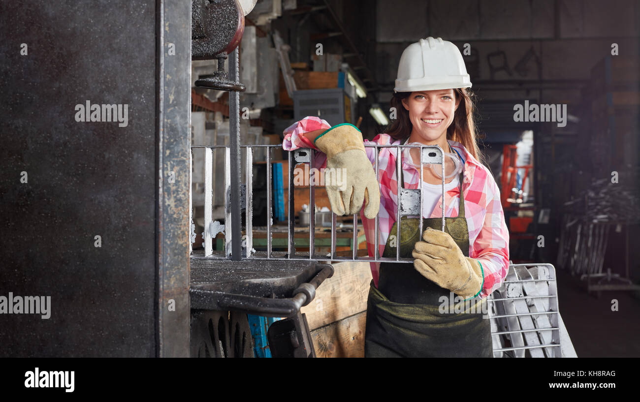 Young woman as metalworker in metallurgy factory Stock Photo