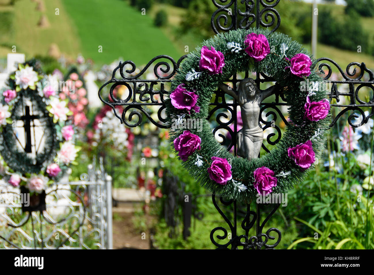 Cemetary adorned with colorful flowers in Bukovina region, Romania. Stock Photo