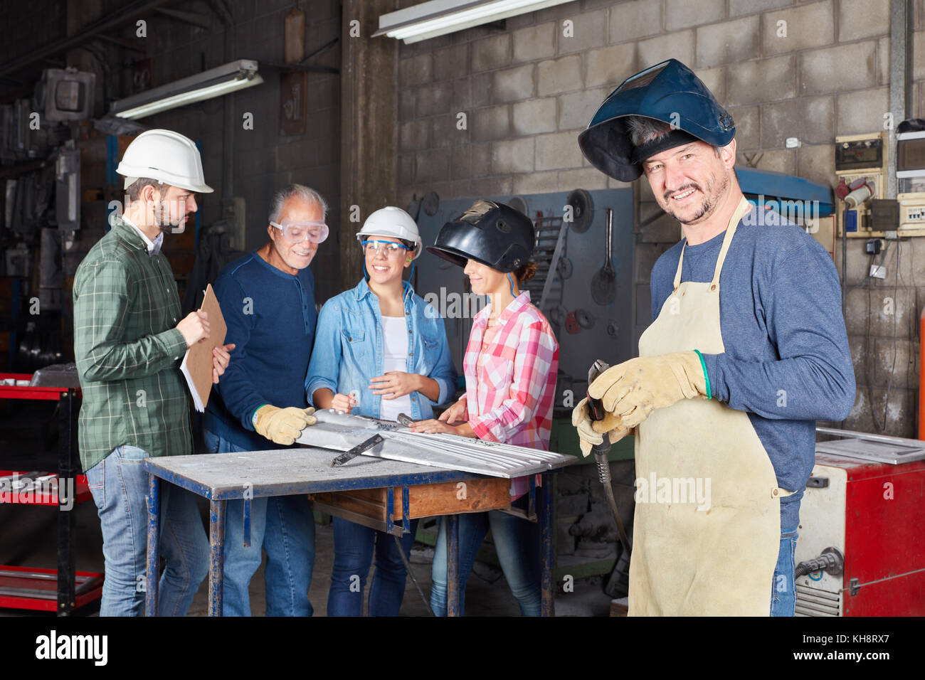 Man as industry operation man working with welder team in cooperation Stock Photo