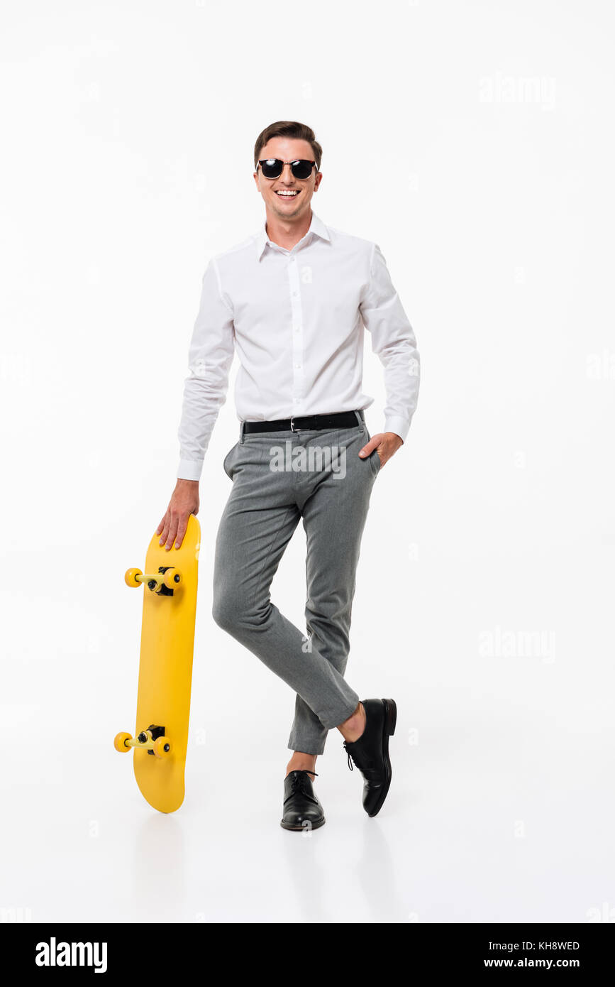 Full length portrait of a handsome smiling man in white shirt and ...