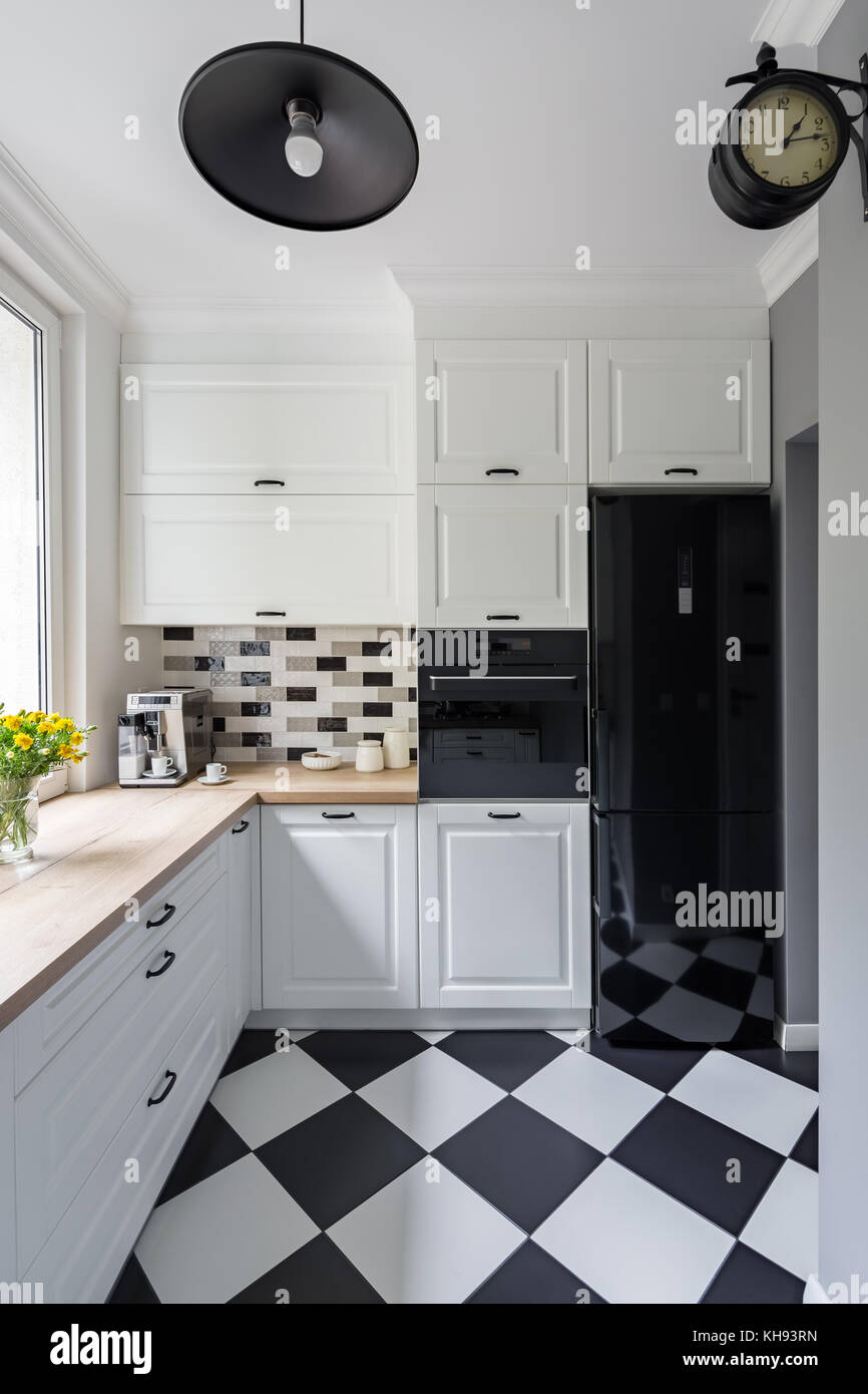 Small White Kitchen With Modern Chess Flooring And Black Fridge