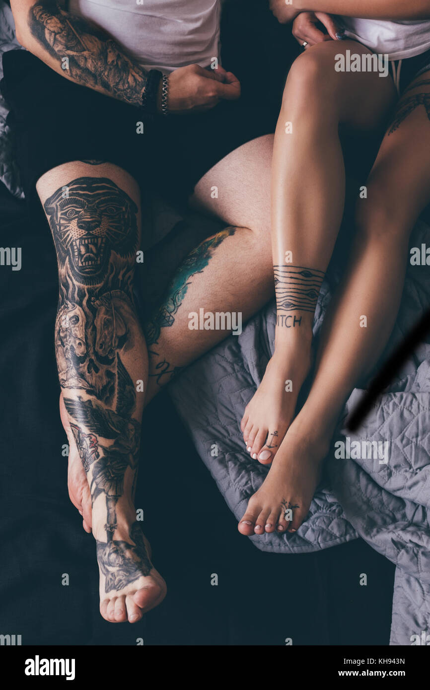 tattooed couple in bed Stock Photo