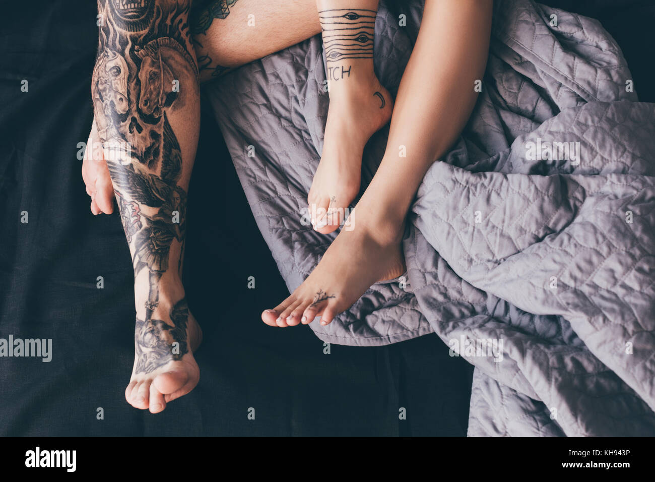 tattooed couple in bed Stock Photo