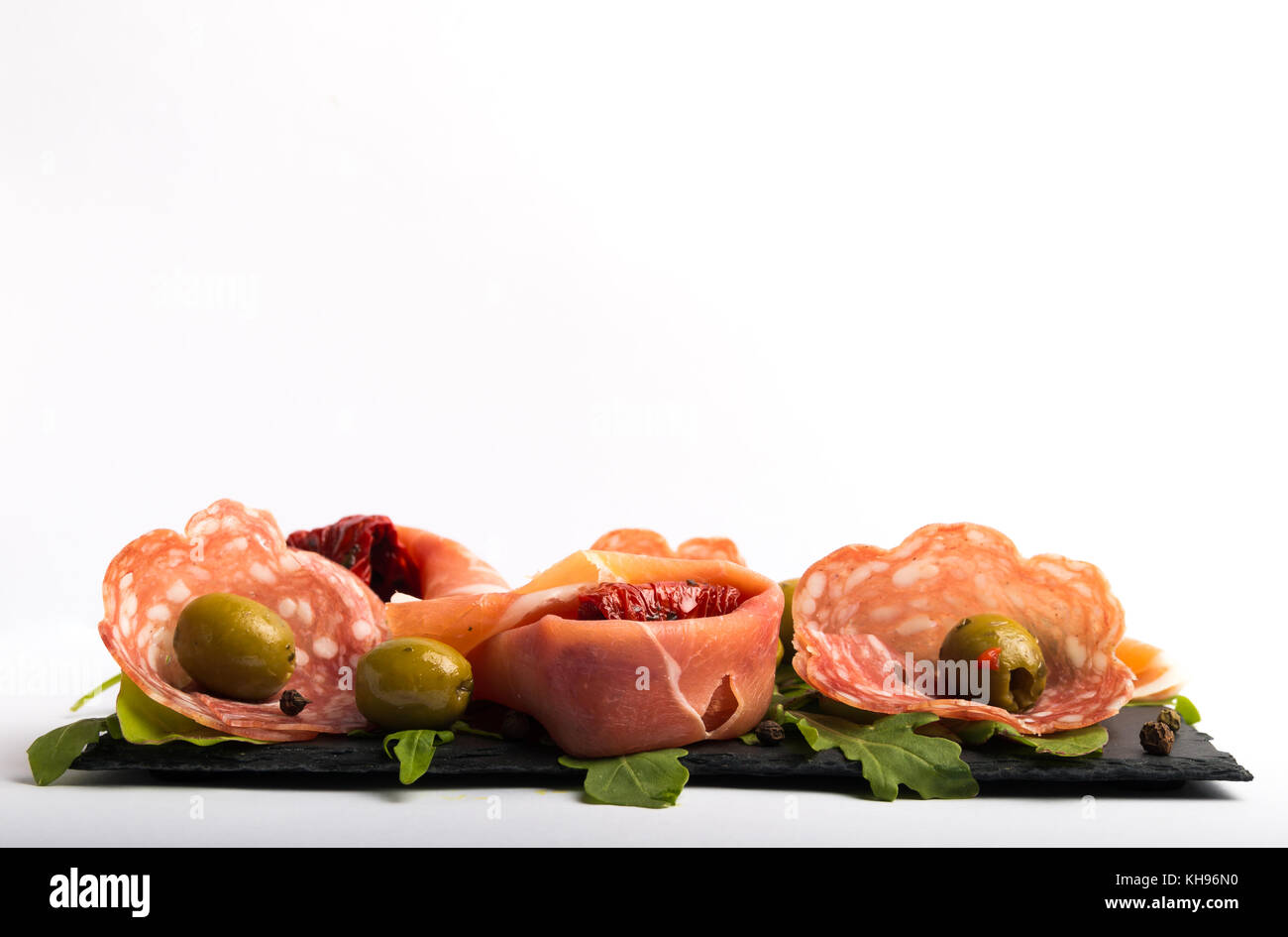 italian antipasto with dried tomatoes and olives front view on a white