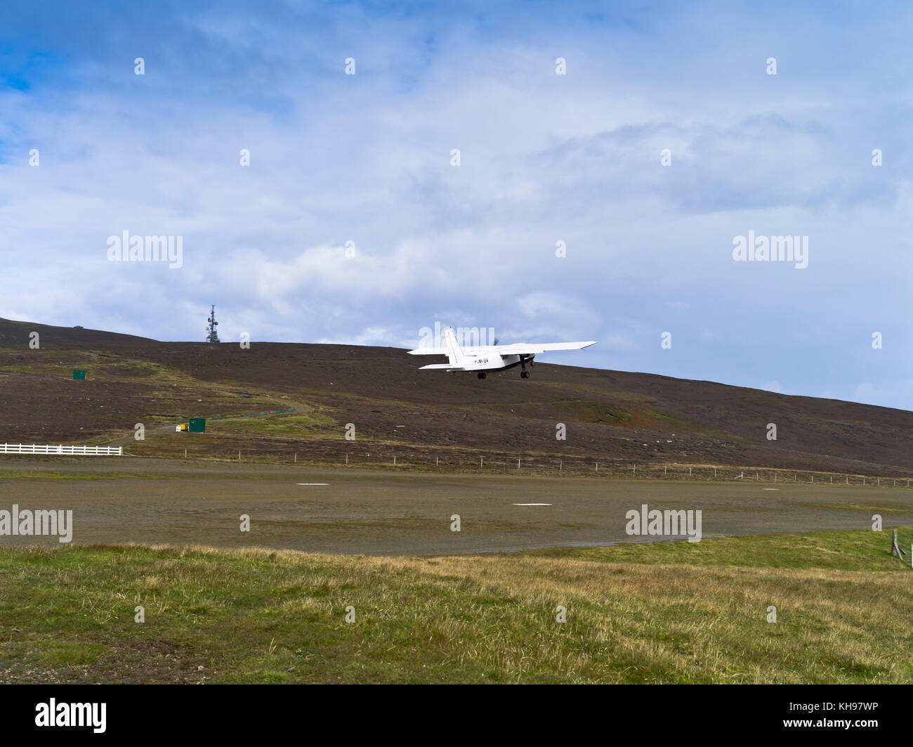 dh FAIR ISLES AIRPORT FAIR ISLE Loganair Islander aircraft turboprop runway taking off airplane airfield scottish islands scotland island Stock Photo