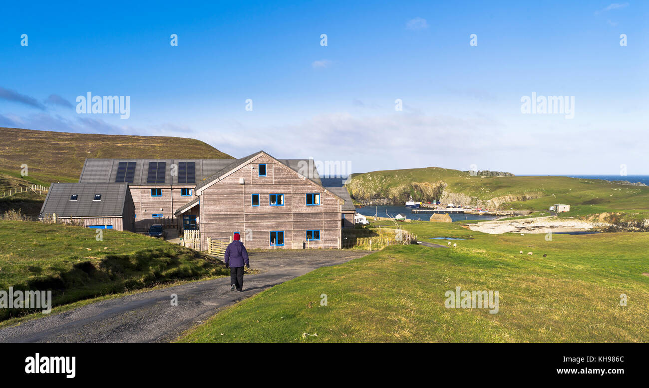 dh BIRD OBSERVATORY FAIR ISLE Hiker woman walking down road to North Haven Stock Photo