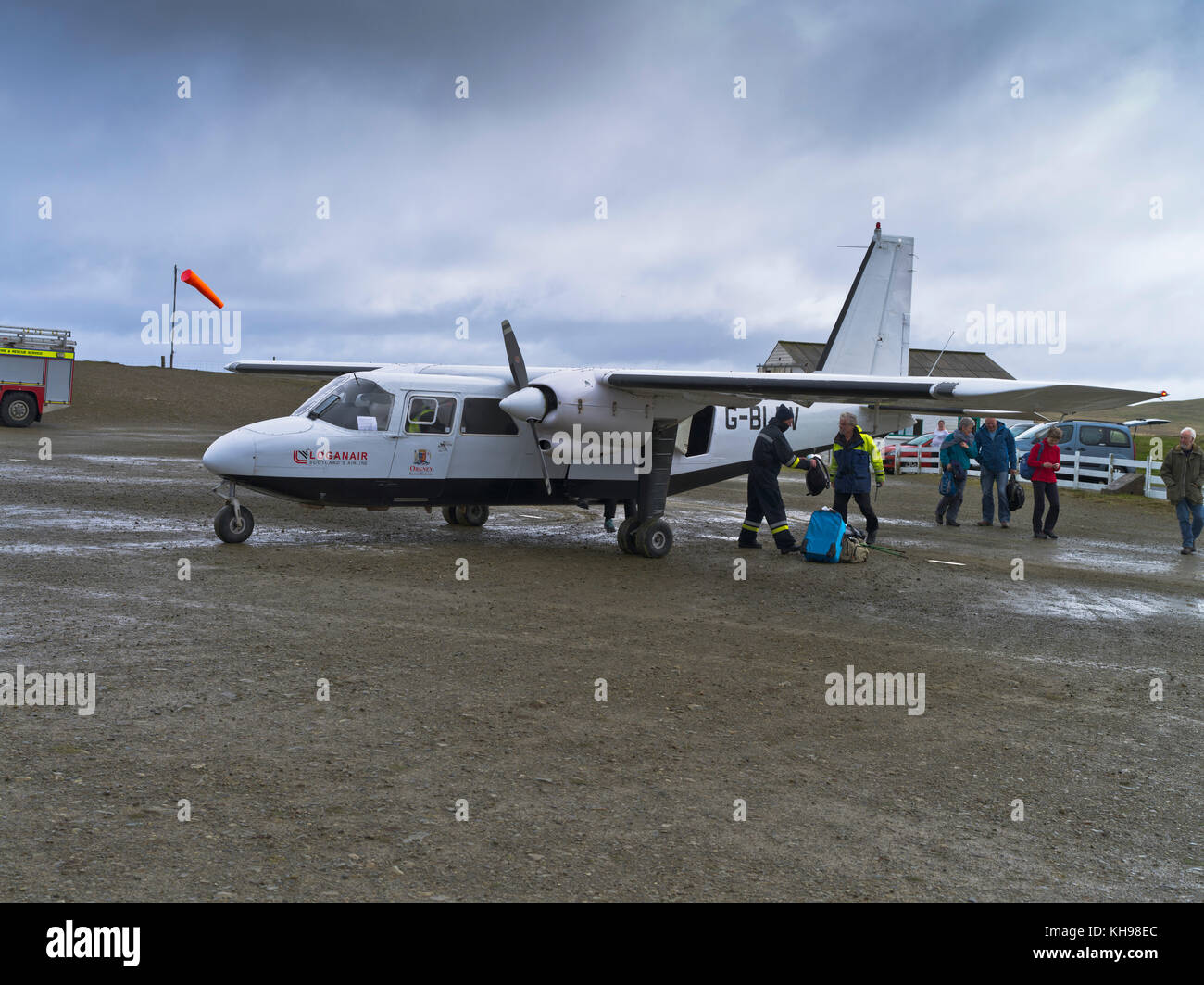 dh  FAIR ISLES AIRPORT FAIR ISLE Scotland Loganair Islander aircraft turboprop discharging passengers baggage islands airplane airfield Stock Photo