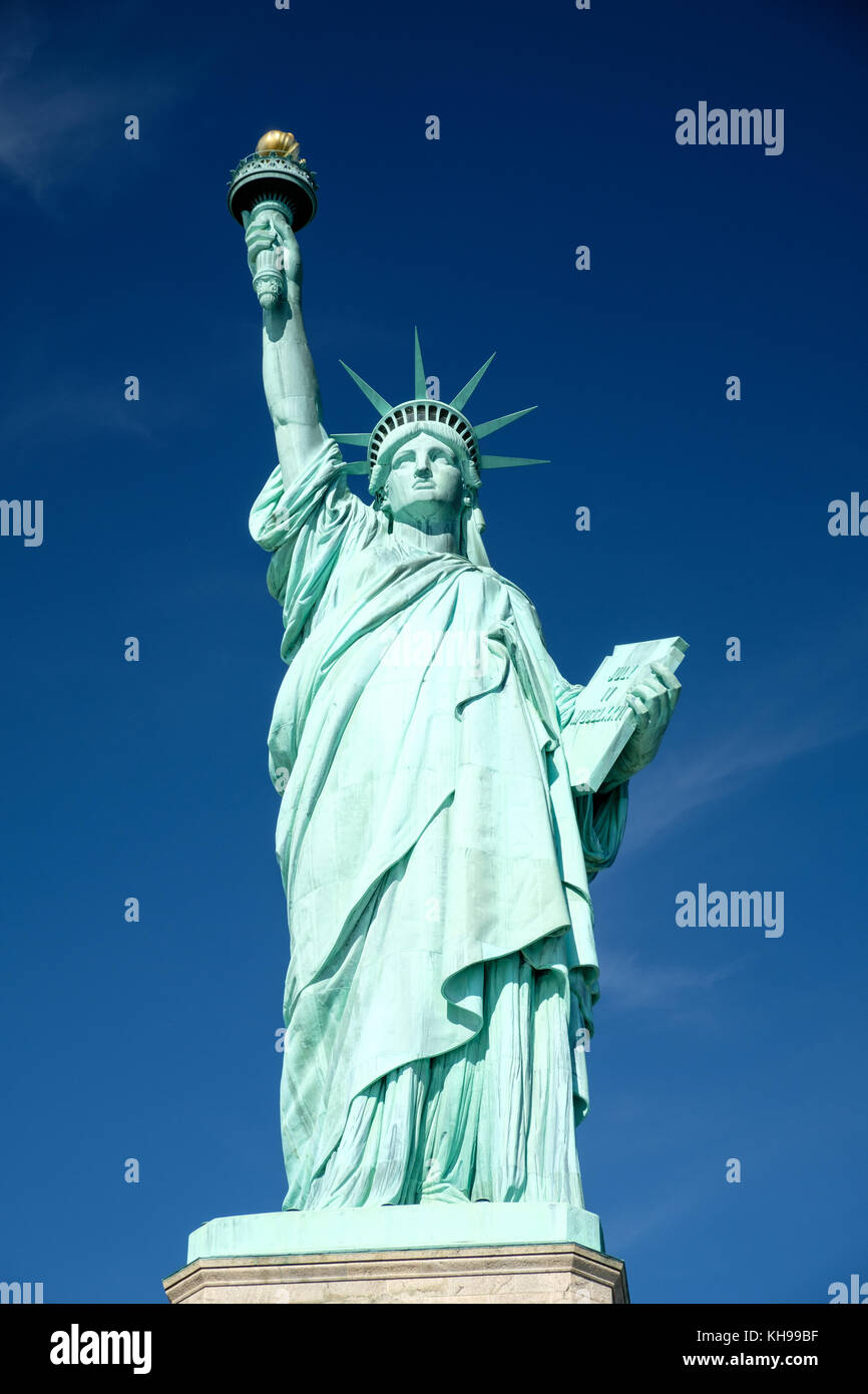 Statue of Liberty close up against a blue sky, also known as Lady Liberty Stock Photo