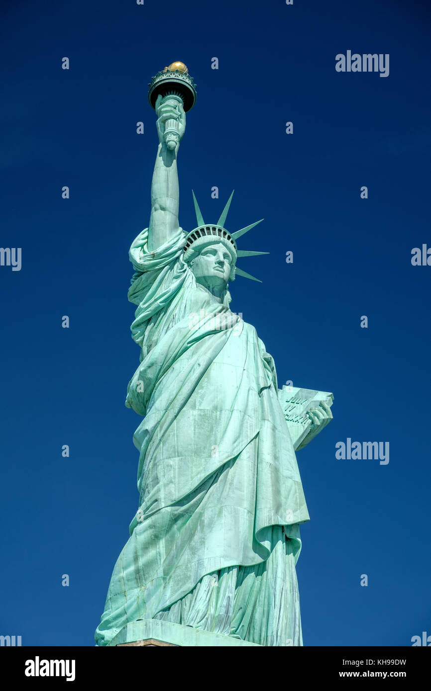 Statue of Liberty close up against a blue sky, also known as Lady