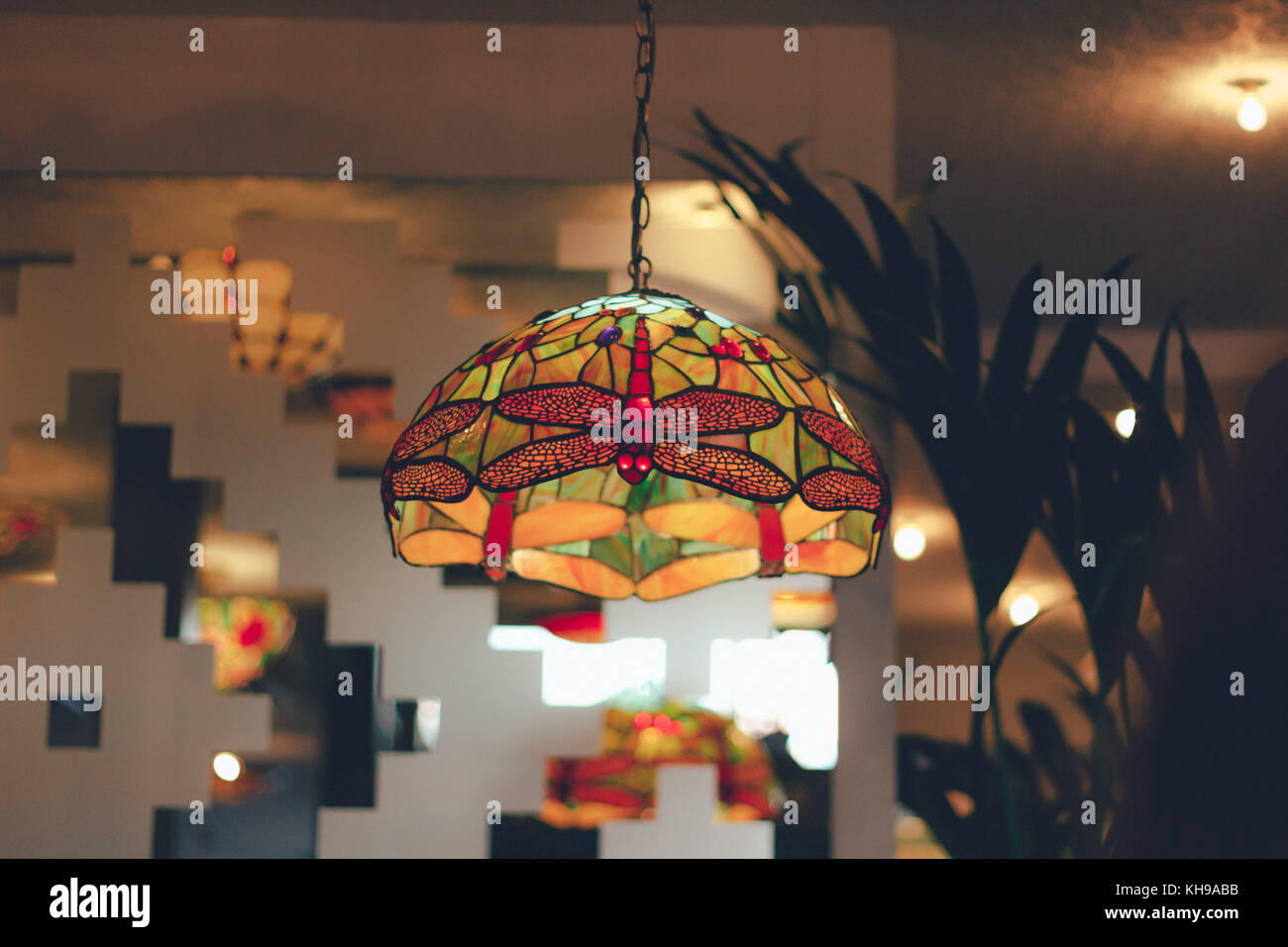 Glass lampshade with butterfly design on stained glass interior Stock